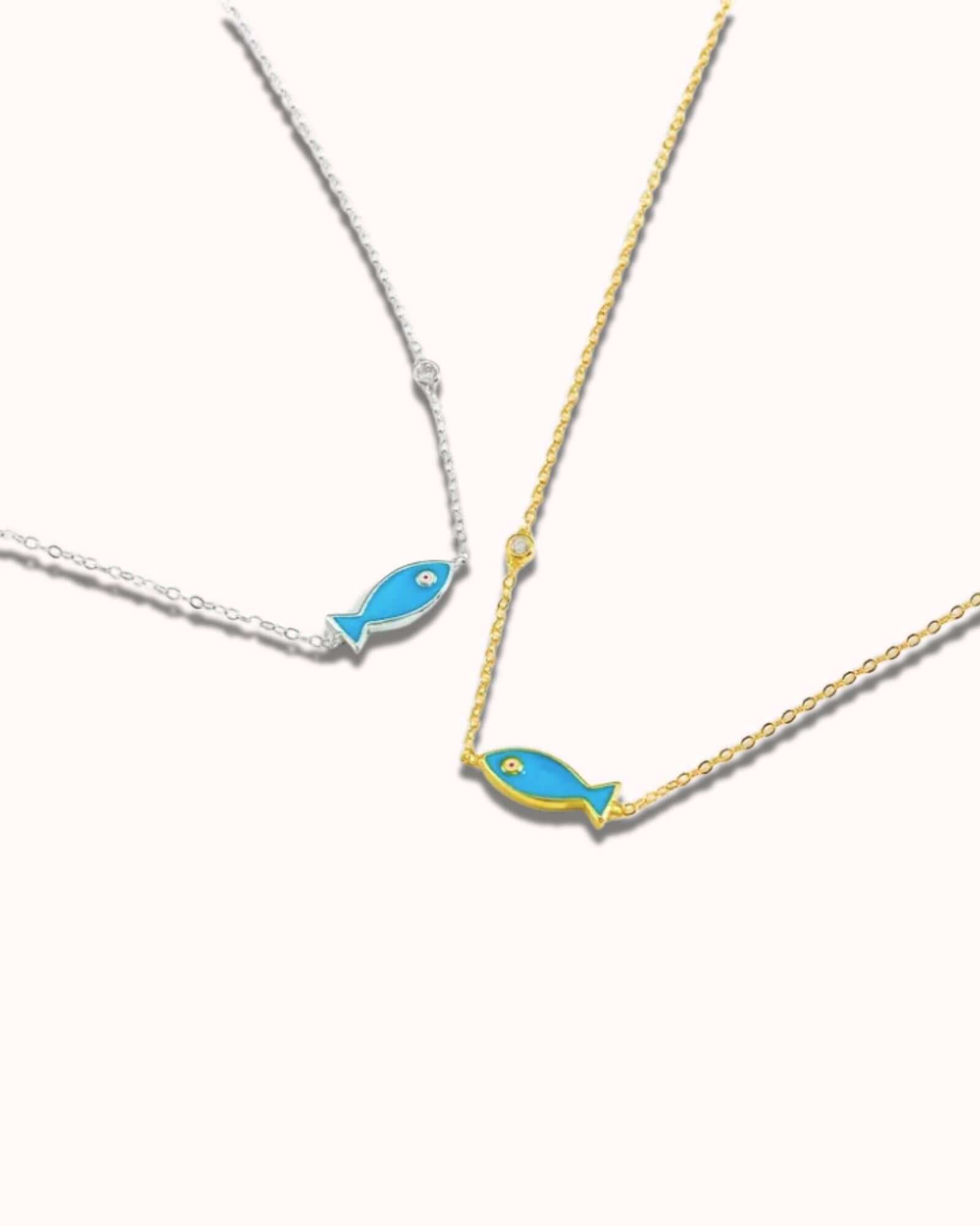 Vintage fish pendant necklace with blue enamel finish on silver and gold chains, perfect for summer jewelry.