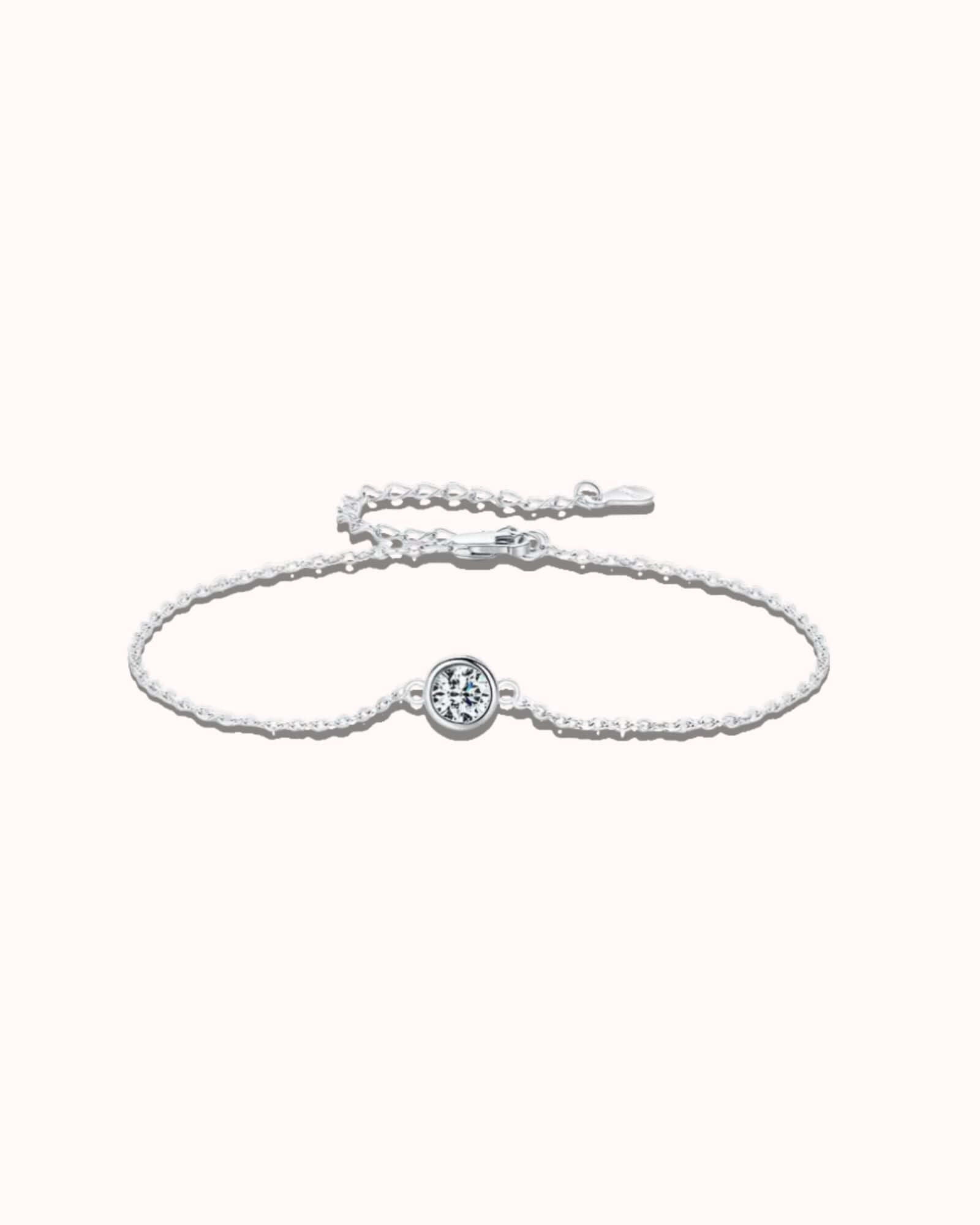 0.5 ct moissanite halo bracelet with a sterling silver cable chain and bezel-set moissanite stone.