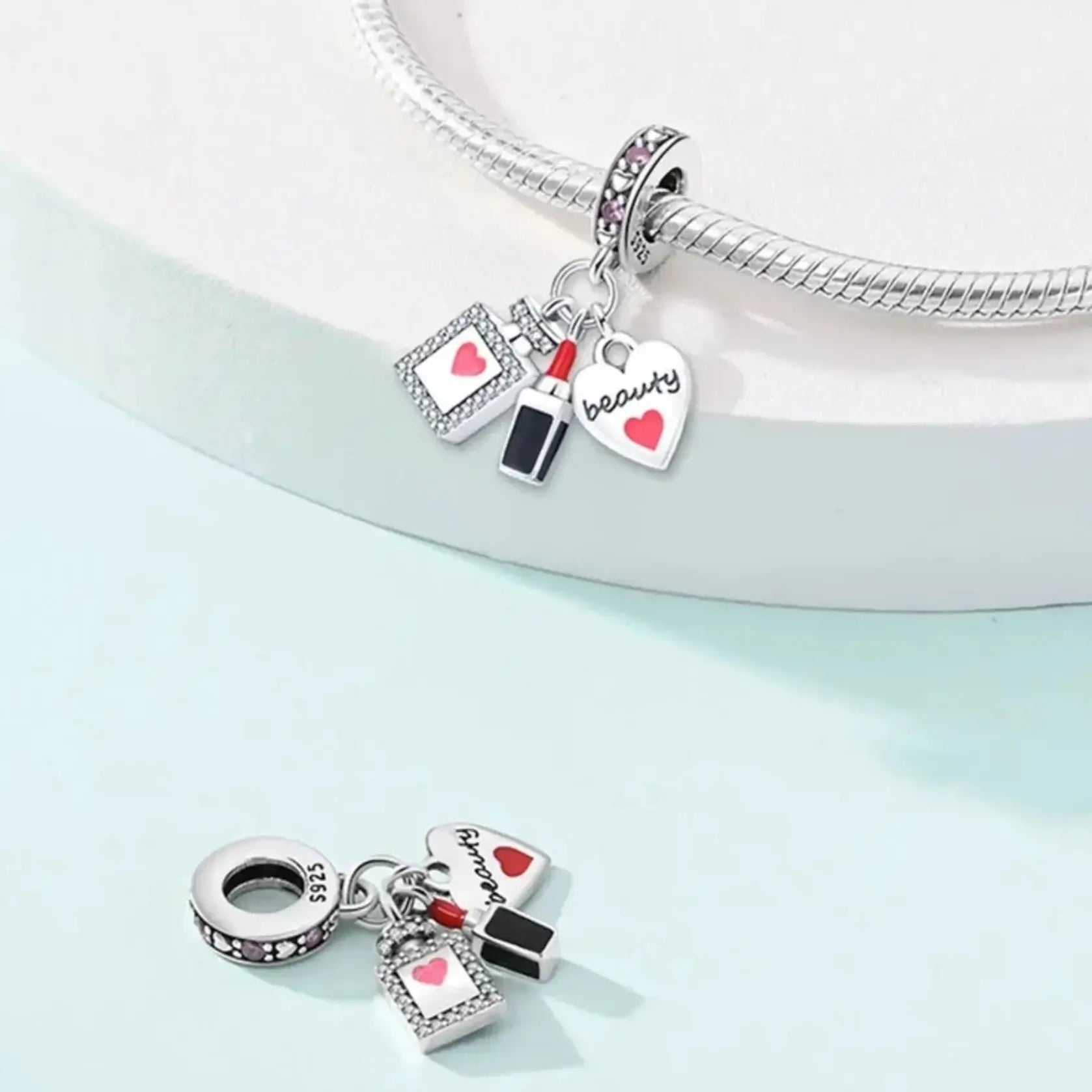 Silver bracelet with charms on a light blue background