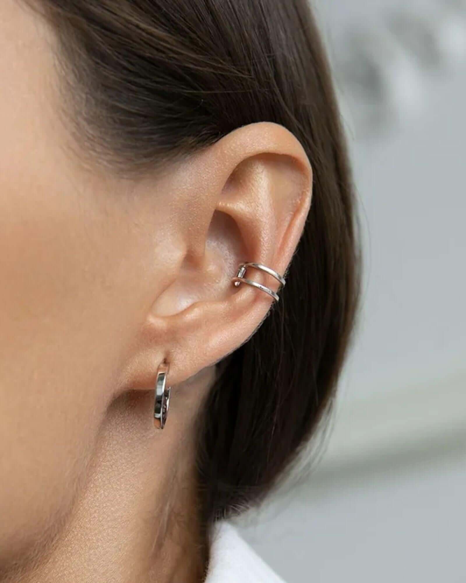 Double ear cuff jewellery in silver worn on an ear, showcasing a stylish double-layered look.