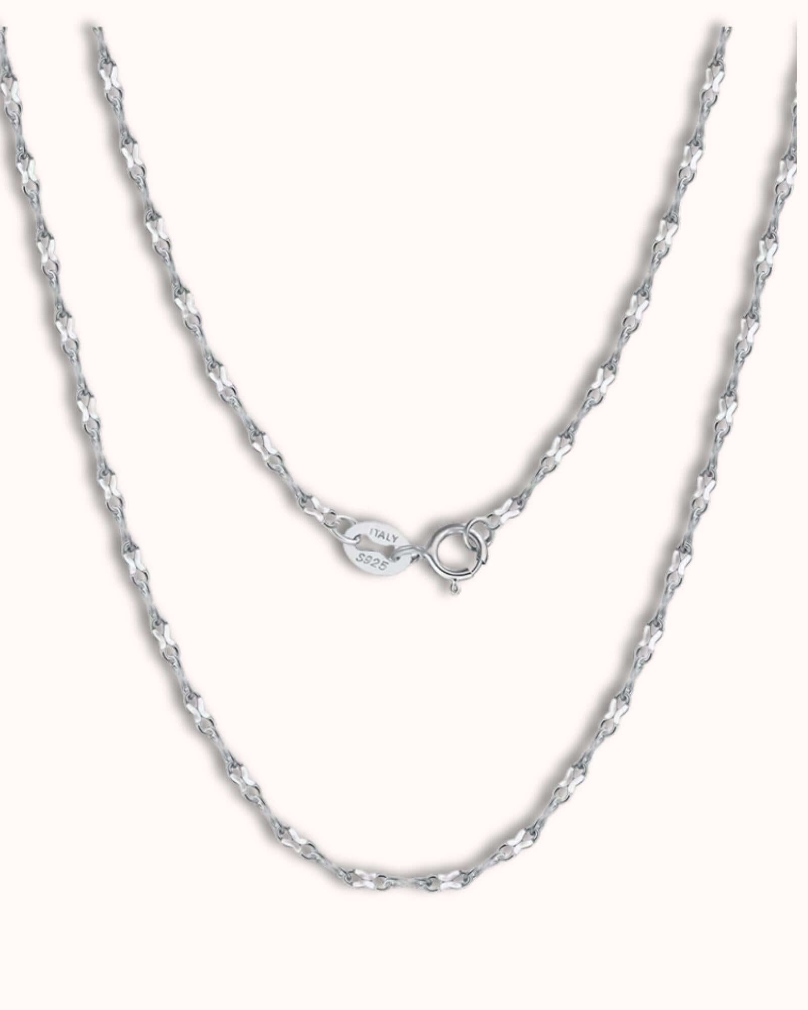 Simple figure eight chain in silver, featuring delicate interlocking links and a classic design.