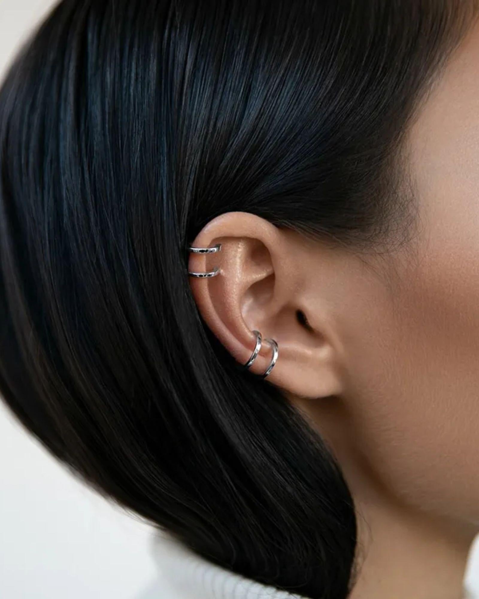 Double Band Ear Cuff in Silver showcased on a model's ear, featuring a sleek and modern design.