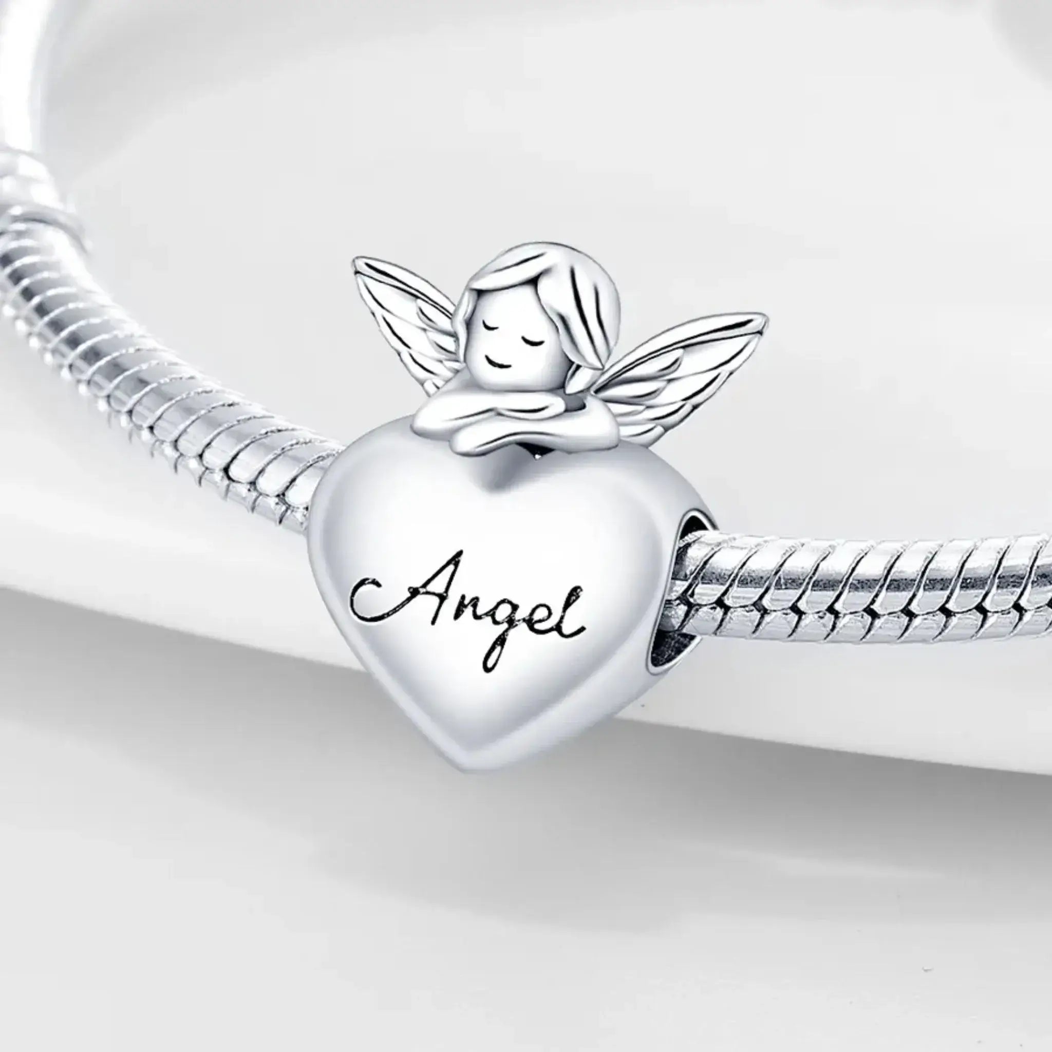 Silver charm with angel and 'Angel' text on a white background