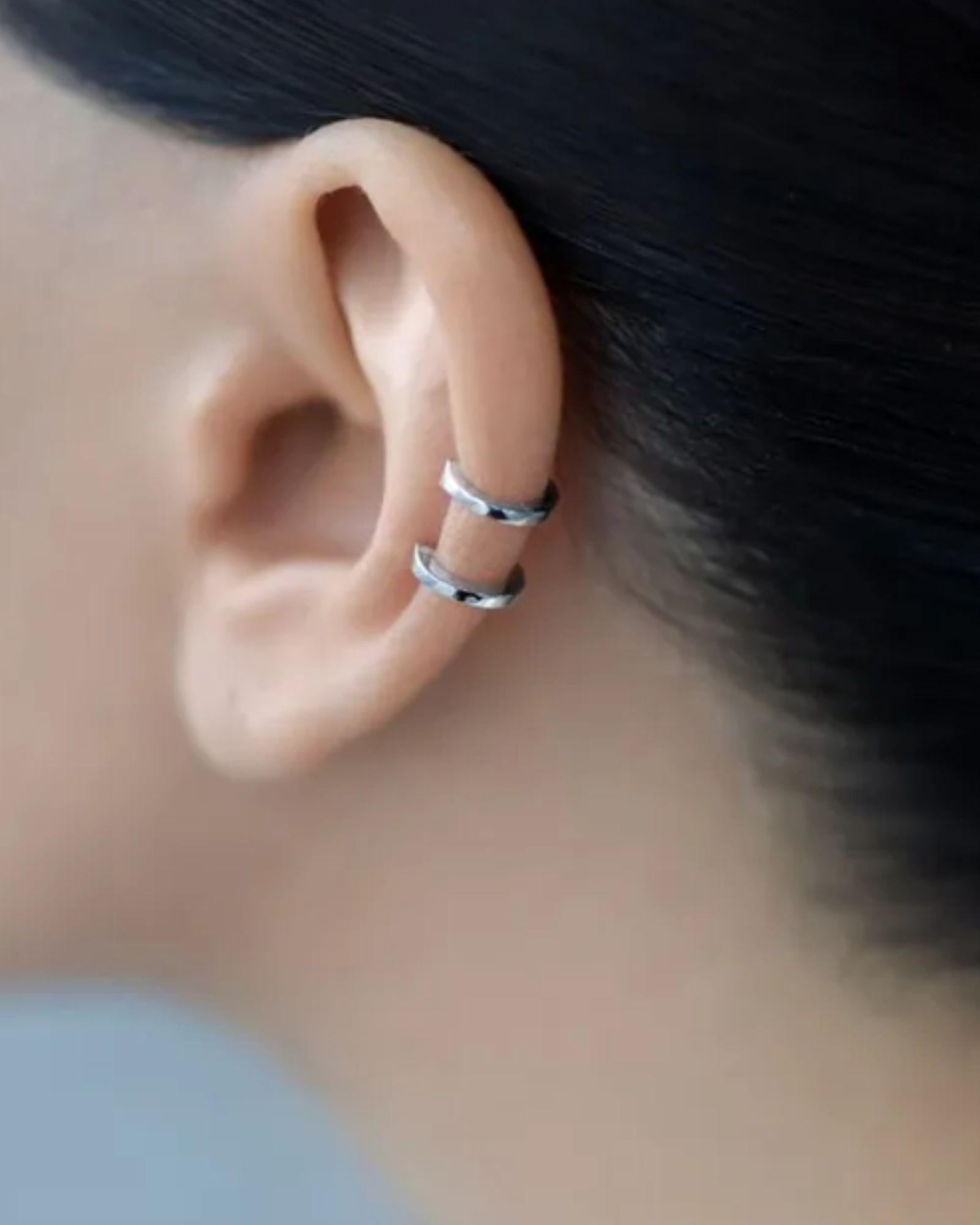 Double Band Ear Cuff in Silver worn on the ear, showcasing its minimalist and modern design.