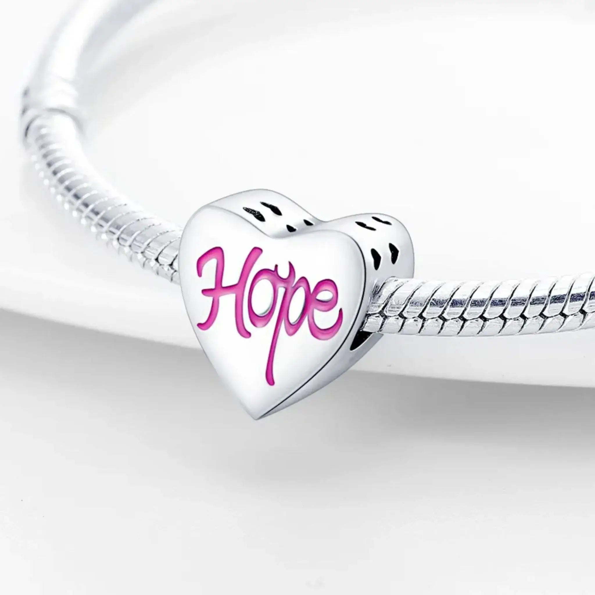 Heart-shaped charm with 'Hope' in pink on a silver snake chain against a white background
