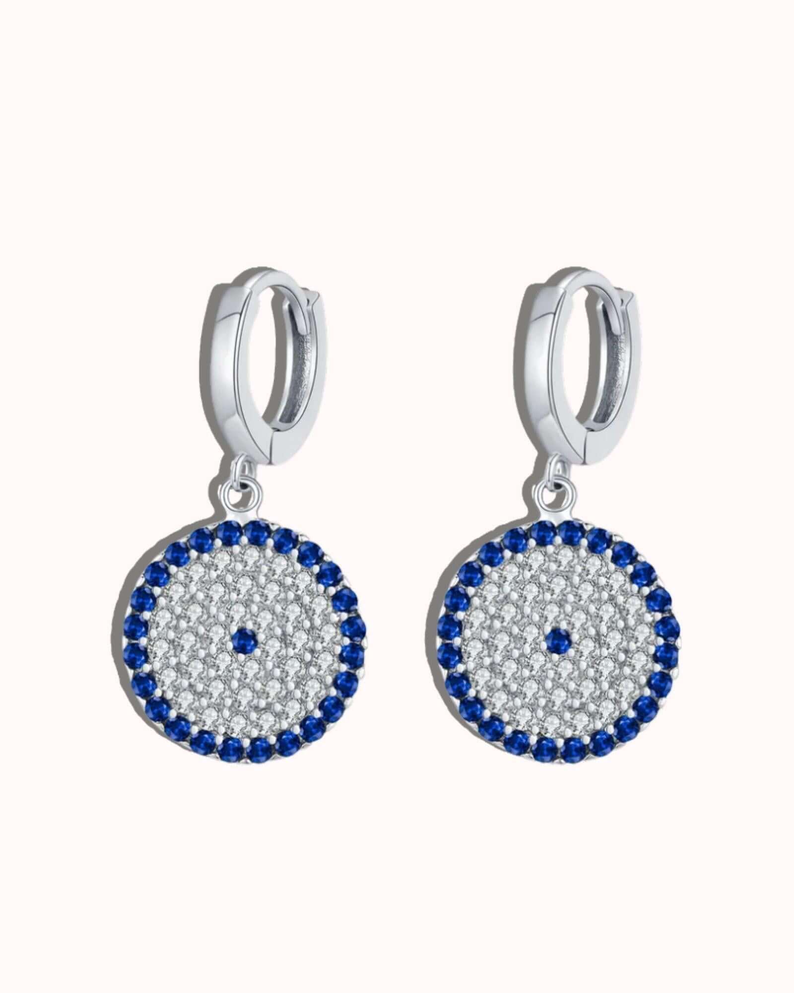 Circle Evil Eye Earrings in silver with blue zircon inlay and polished rhodium-plated design.