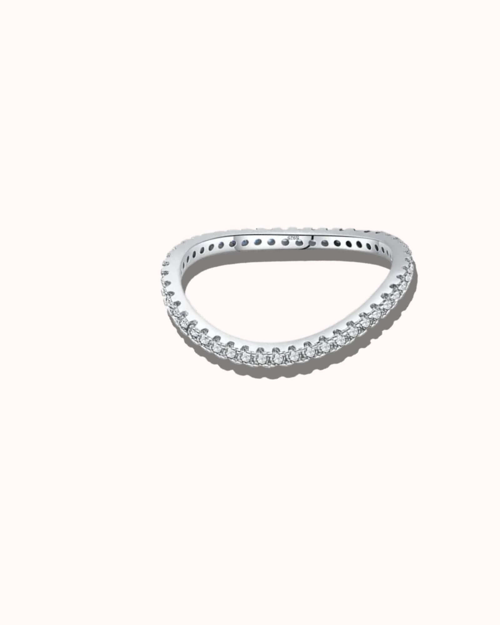Silver ring with small diamonds on a white background