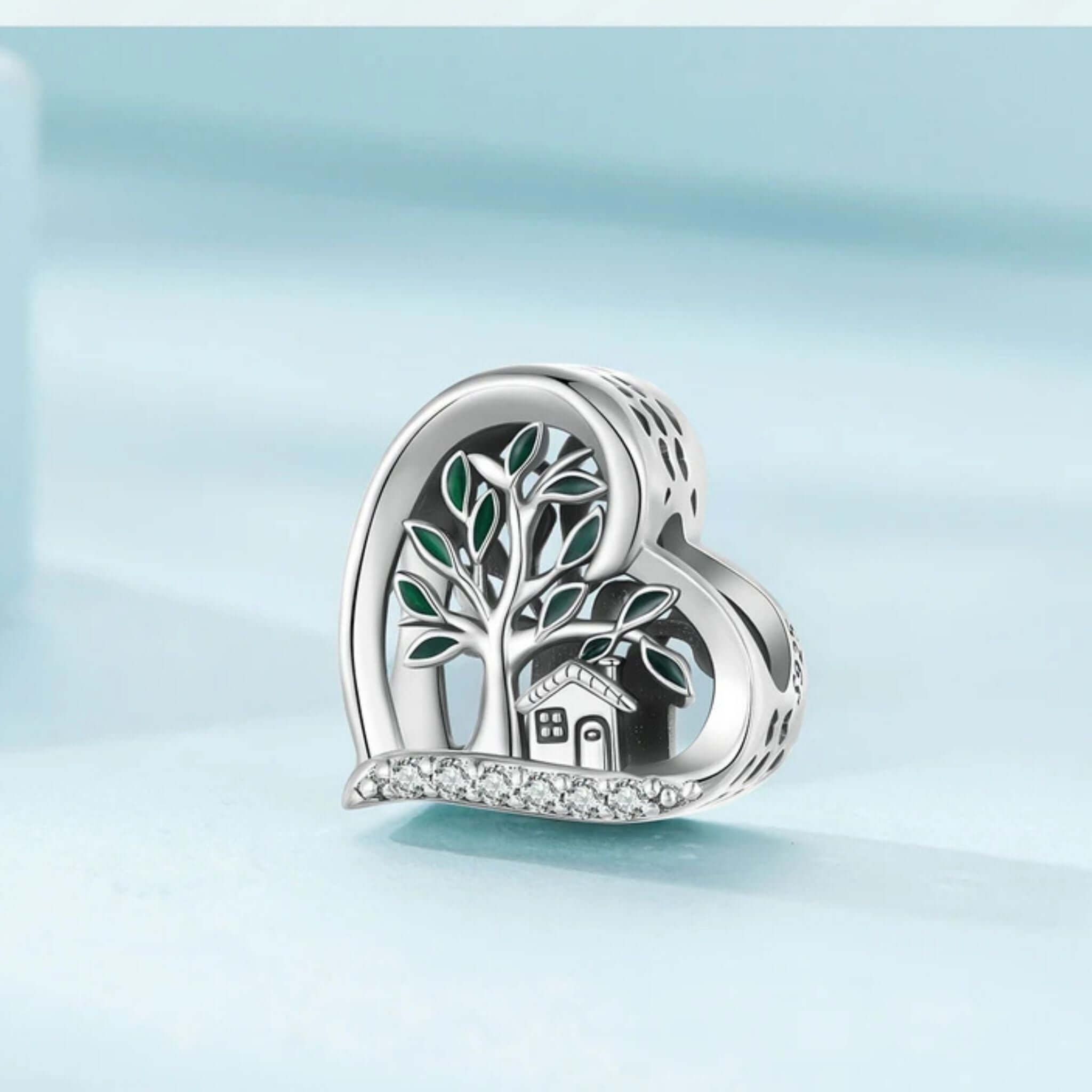 Sterling silver Tree of Life charm in heart shape, featuring a house and cubic zirconia accents, symbolizing love and vitality.