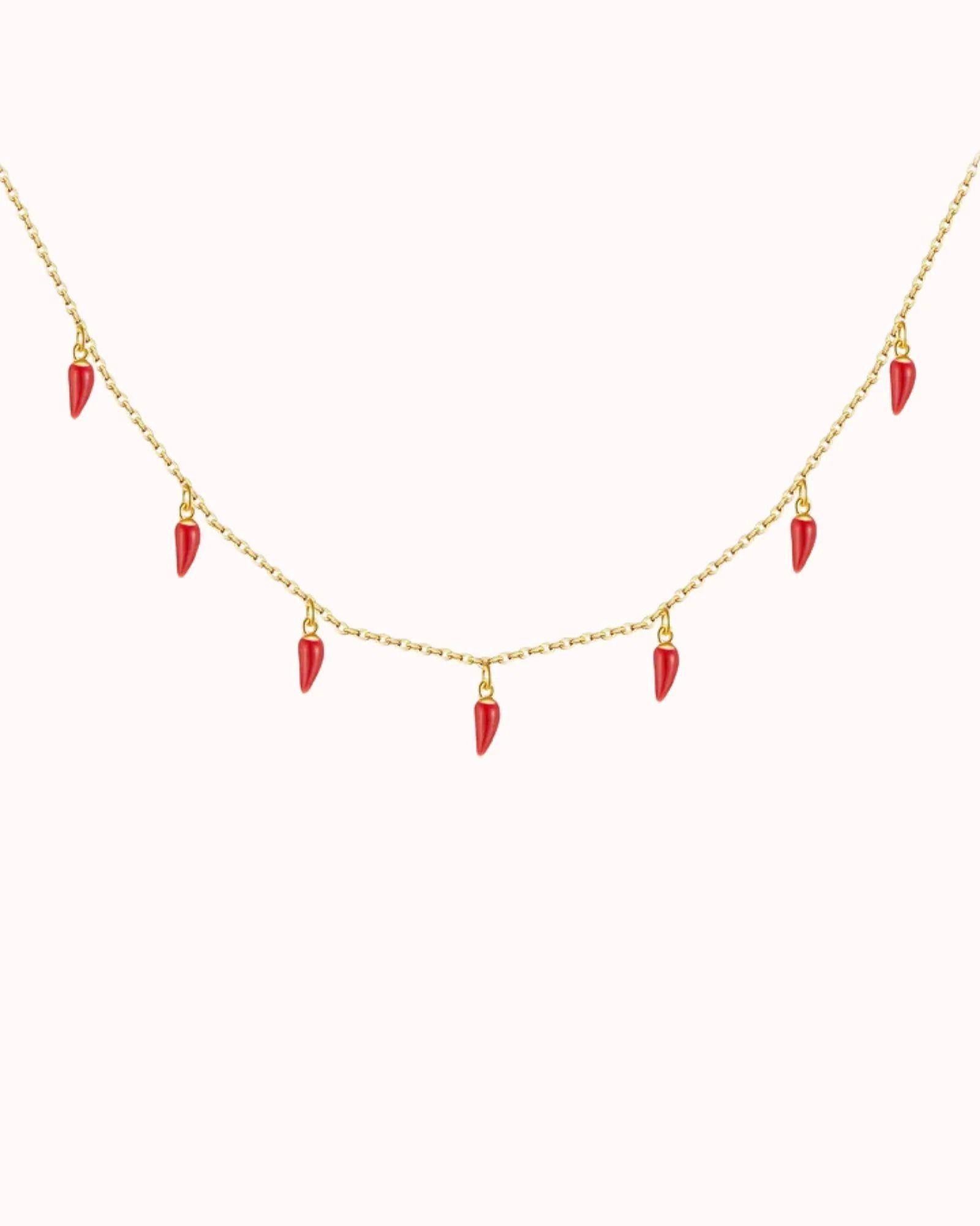 Spicy Bloom Chilli Charm Necklace featuring delicate red chilli charms on a gold chain.