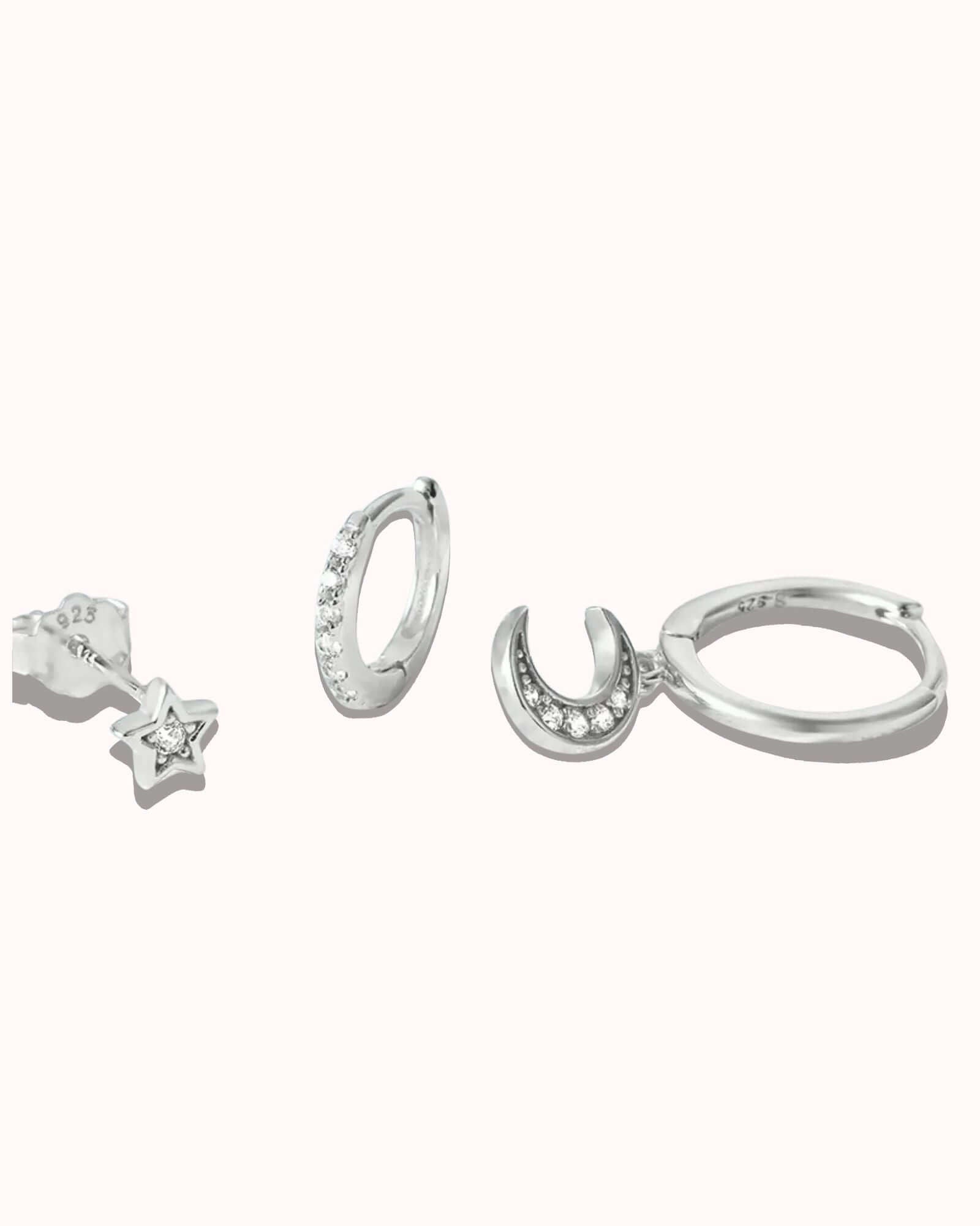 Three piece Lunaria earring set in sterling silver featuring star and moon designs with zircon inlay.