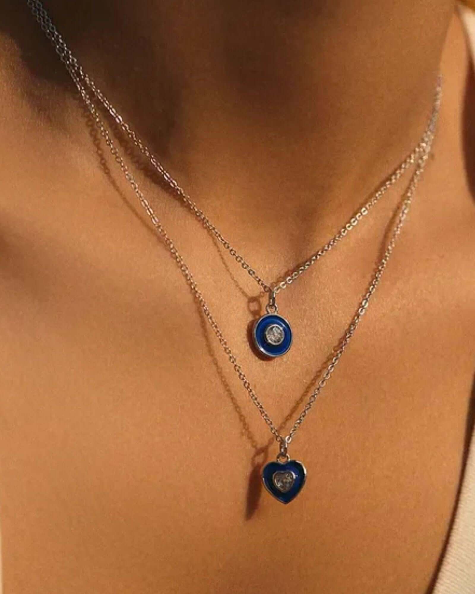 Vintage Devil's Eye pendant necklace displayed in layered design with blue and silver accents.