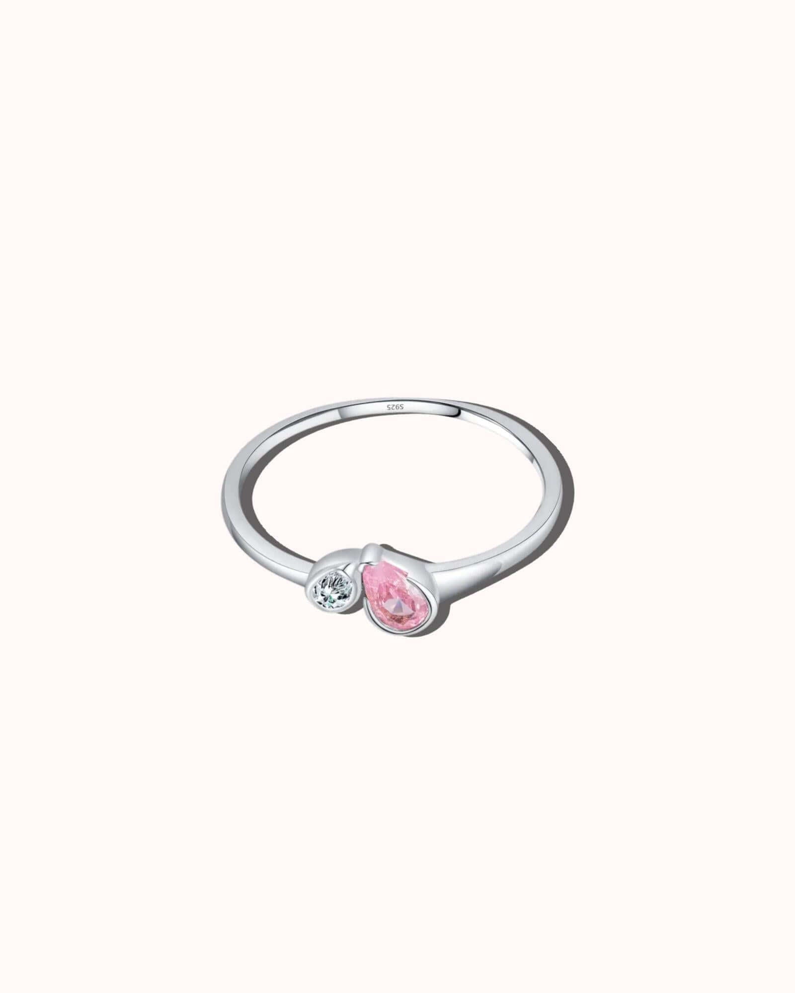 Silver ring with a pink gemstone on a white background