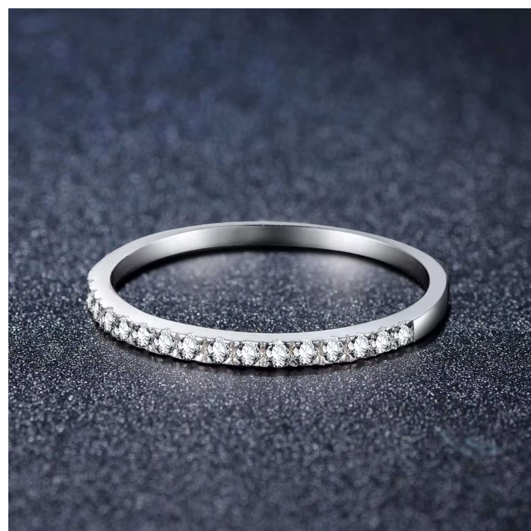 Half Eternity Stackable Ring in Silver showcasing bezel-set zircons on a sleek 925 sterling silver band.
