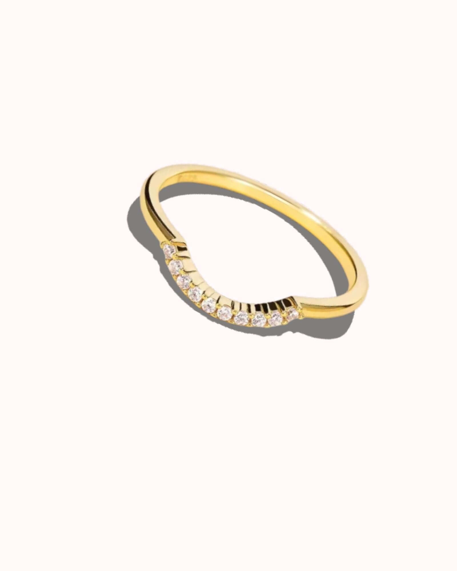 Gold ring with small diamonds on a white background