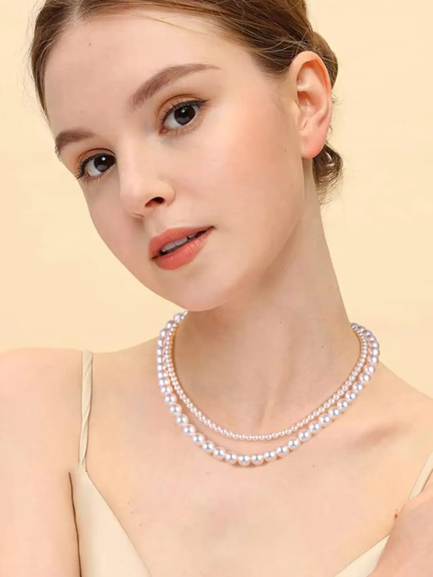 Elegant model showcasing a White Pearl Vintage Choker Necklace, highlighting its timeless beauty and sophisticated design.
