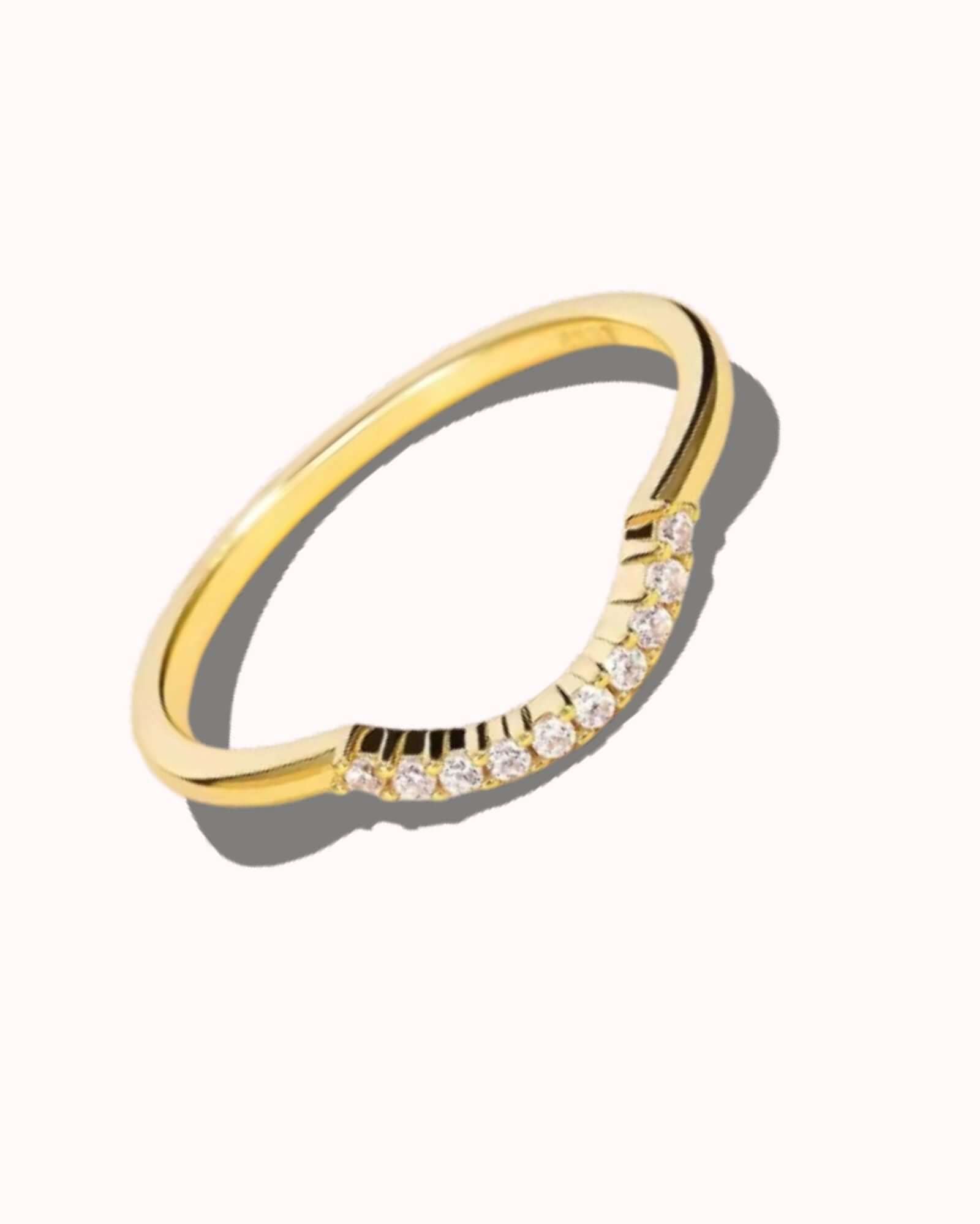 Gold ring with small diamonds on a white background