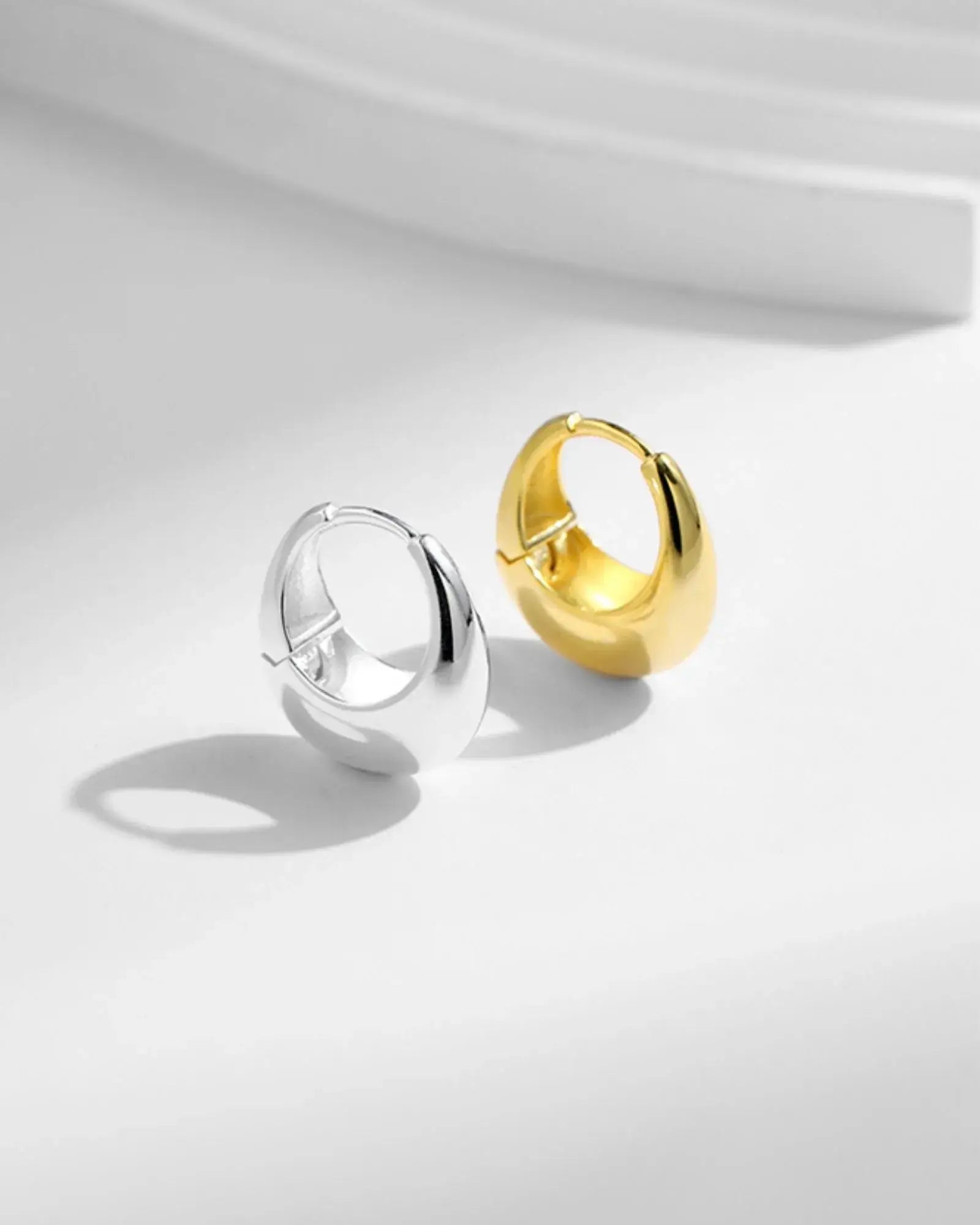 Irregular Solid Hoop Earrings in silver and gold, crafted from 925 sterling silver for modern elegance.