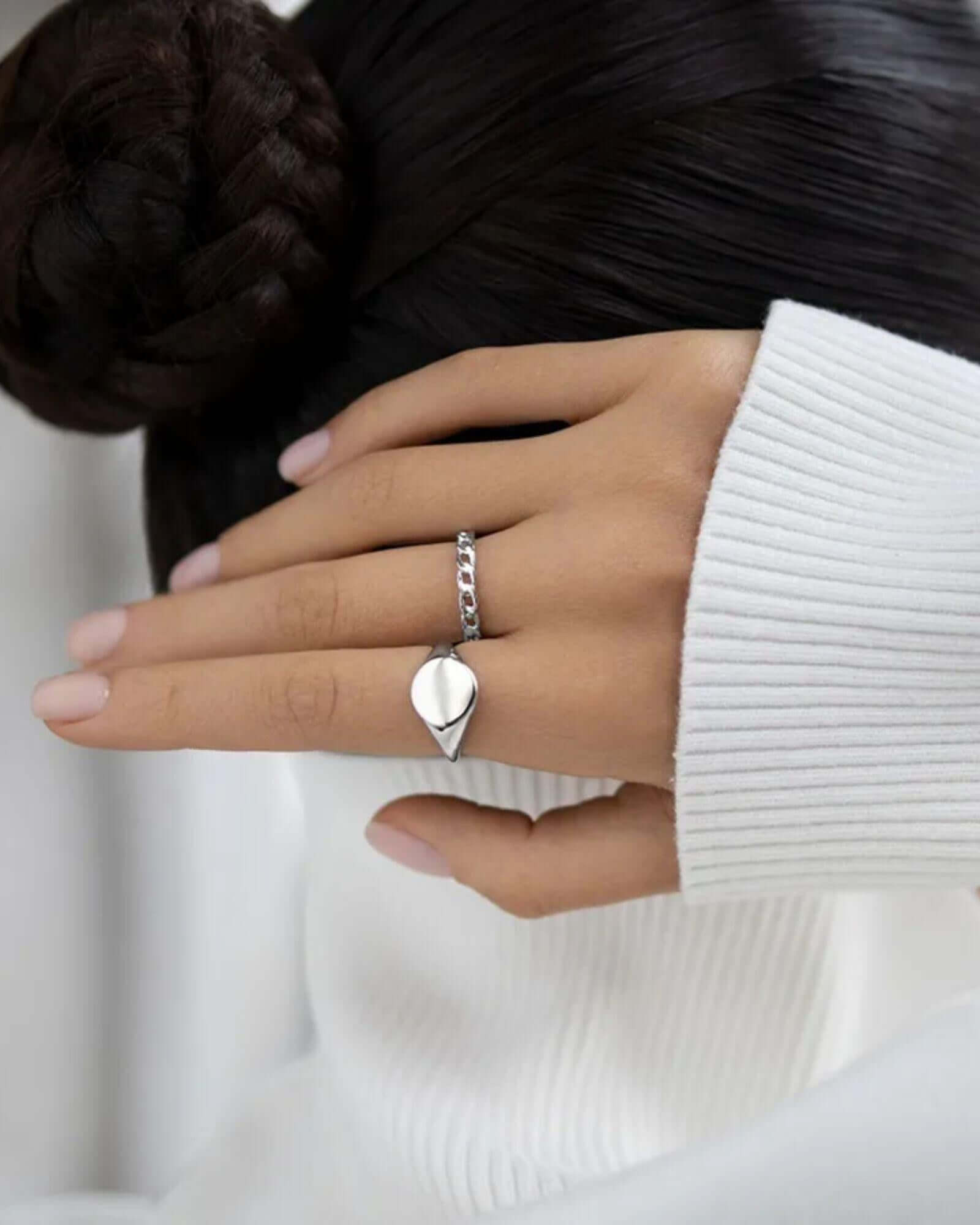 Linked Grace silver ring worn on a hand, showcasing its elegant design and interlocking links.