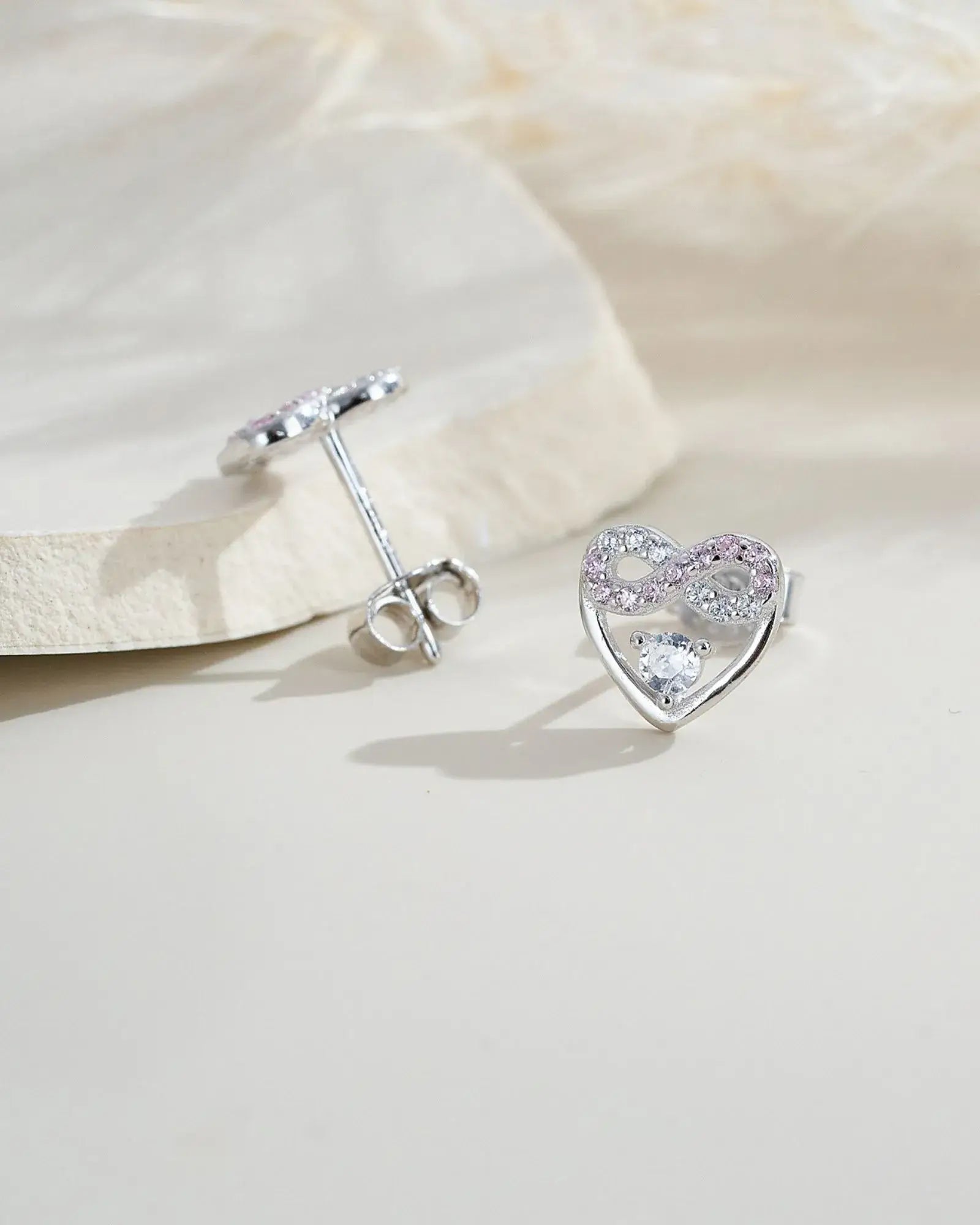 Eternal Blush Heart Ear Studs in sterling silver, featuring pink and white stones, symbolizing everlasting love.