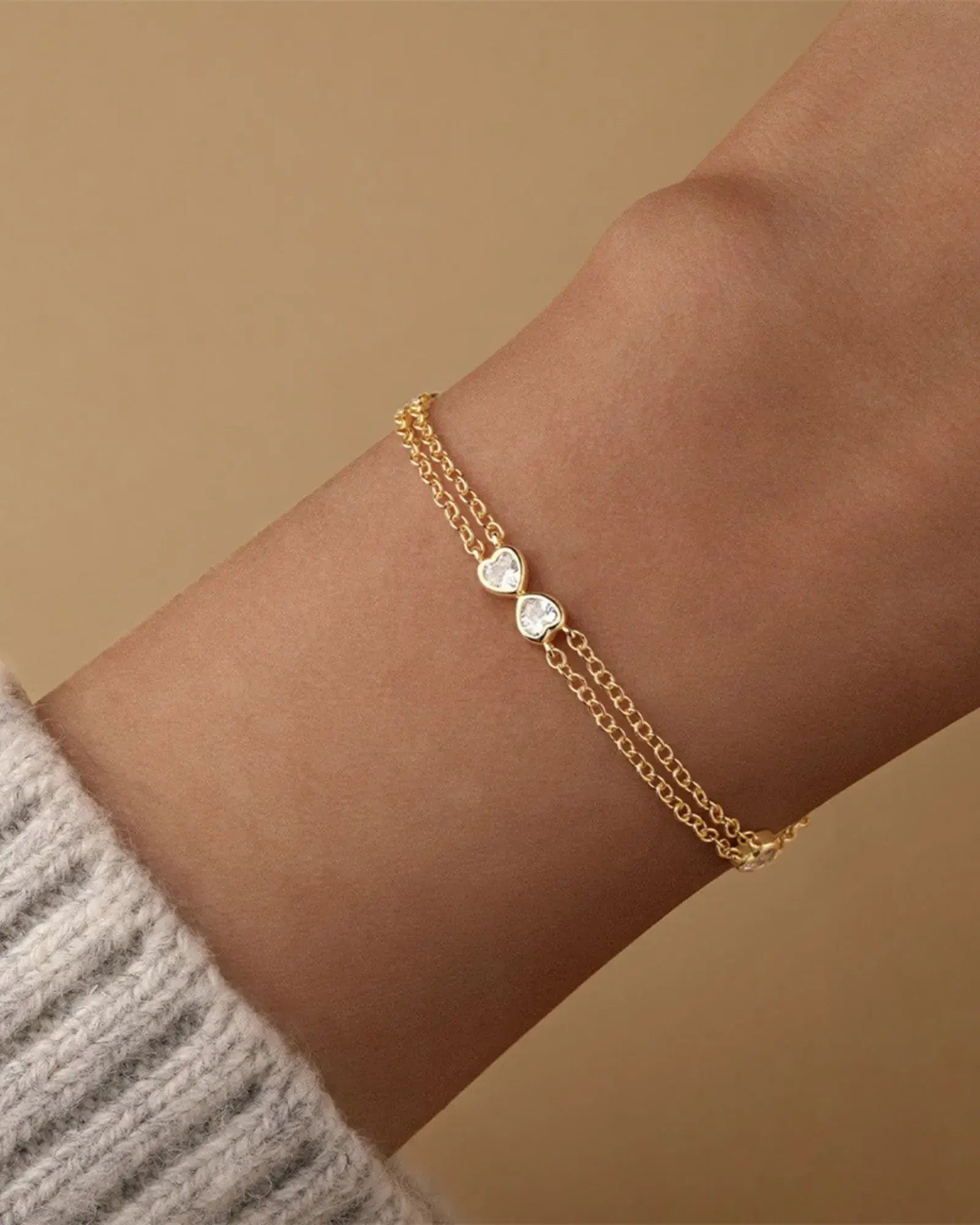 Heart Bow Bracelet in gold with cubic zirconia, featuring a delicate two-layer cable chain design.