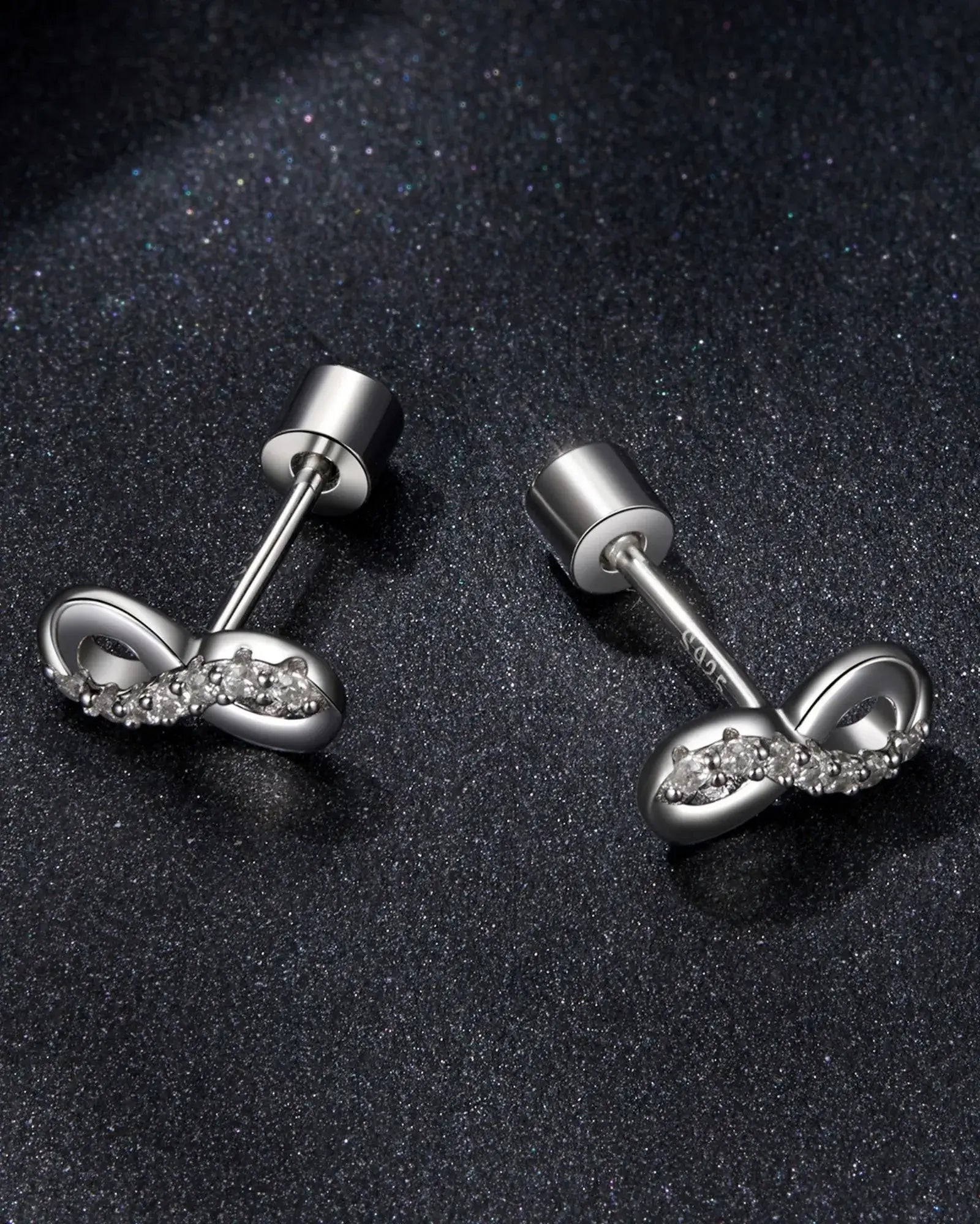Elegant infinity ear studs in 925 sterling silver with moissanite inlay, perfect for everyday sophistication.