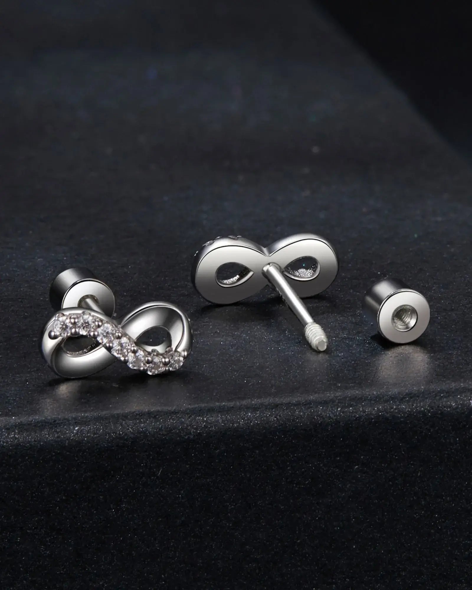 Elegant infinity ear studs in 925 sterling silver with moissanite inlay, featuring a secure screw back design.