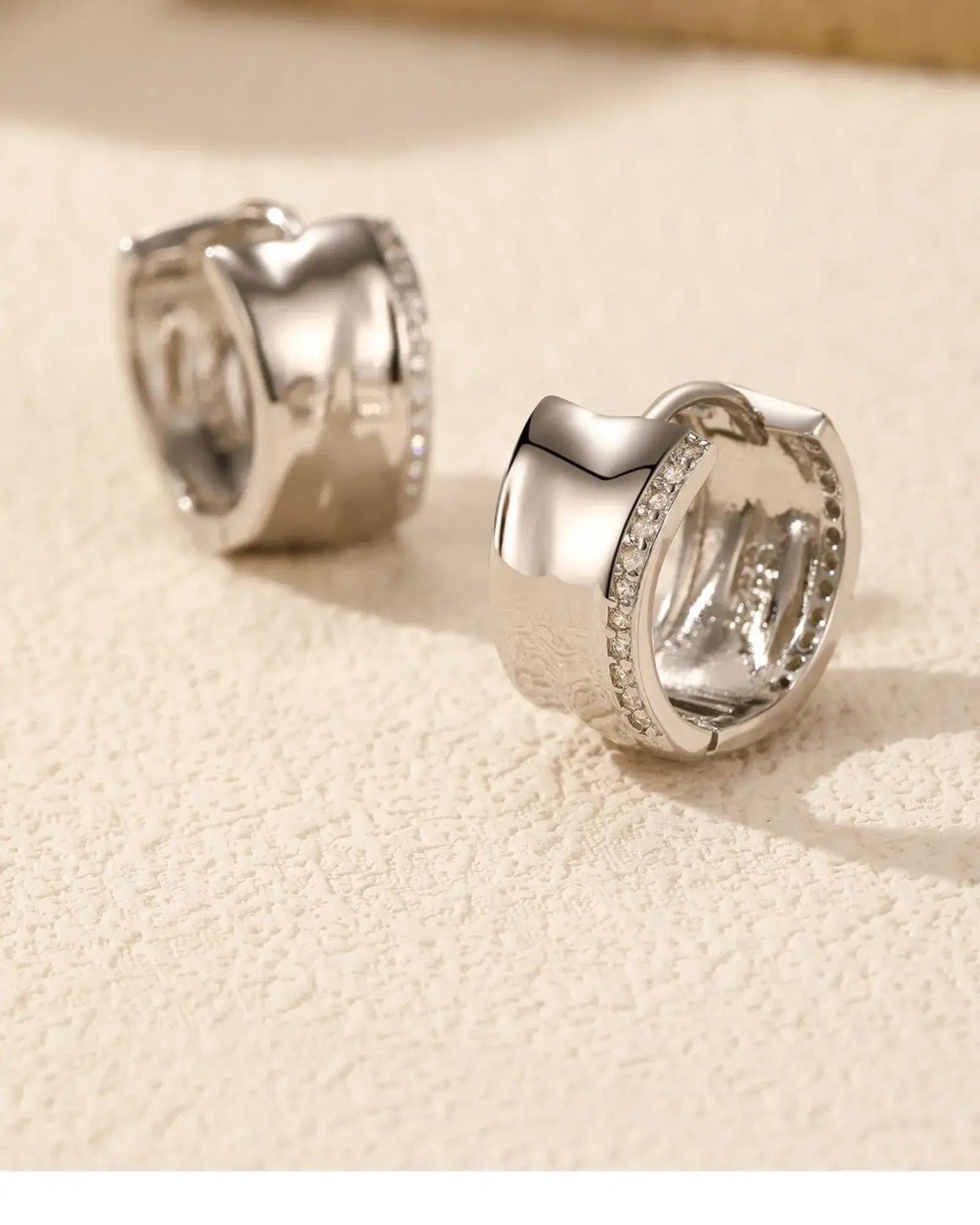 Irregular zircon hoop earrings featuring AAAAA-grade zirconia stones in a pavé setting, showcasing modern elegance.