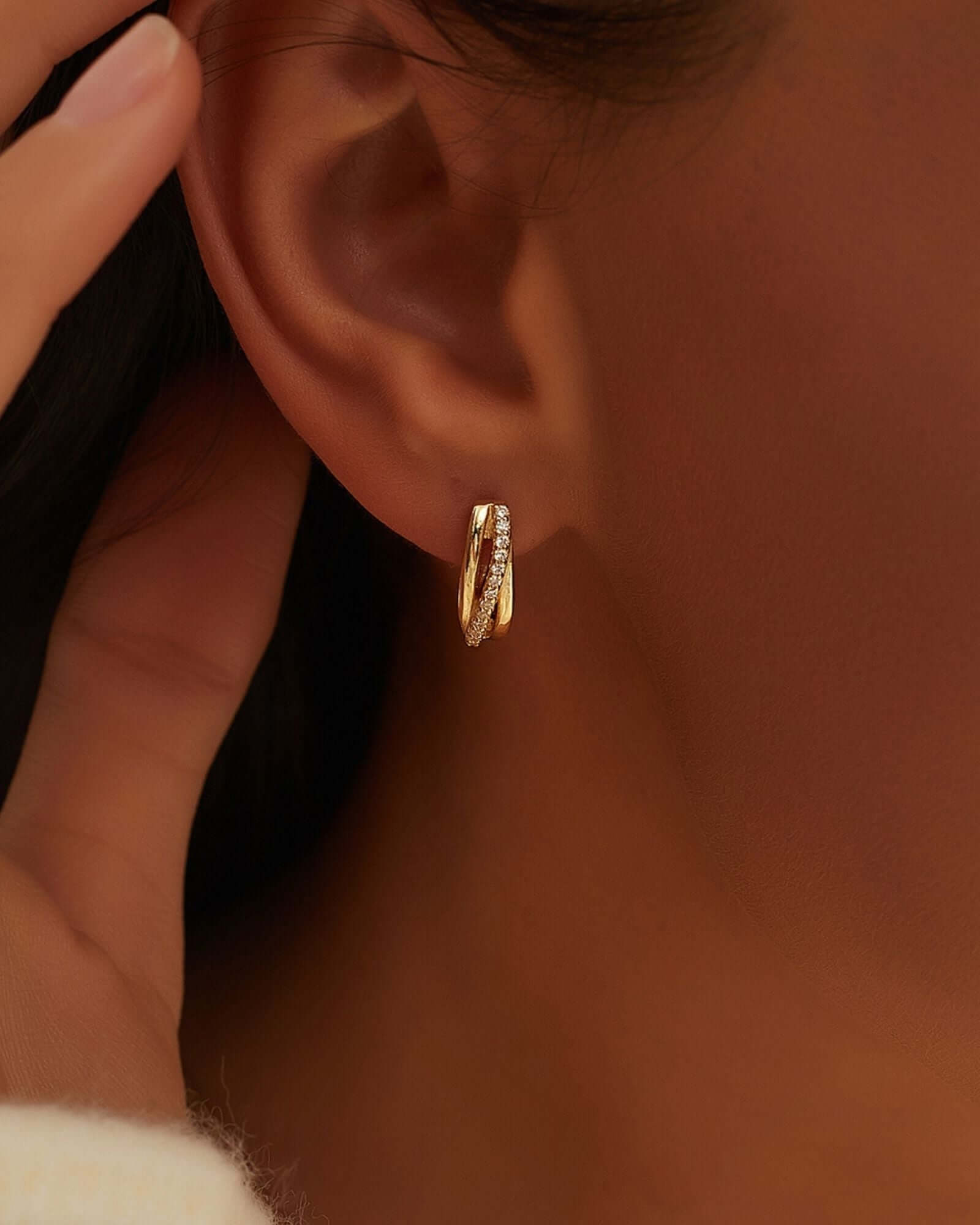 Lux Hoop Earring in 18k gold plating with cubic zirconia, showcasing a stylish triple hoop twist design.