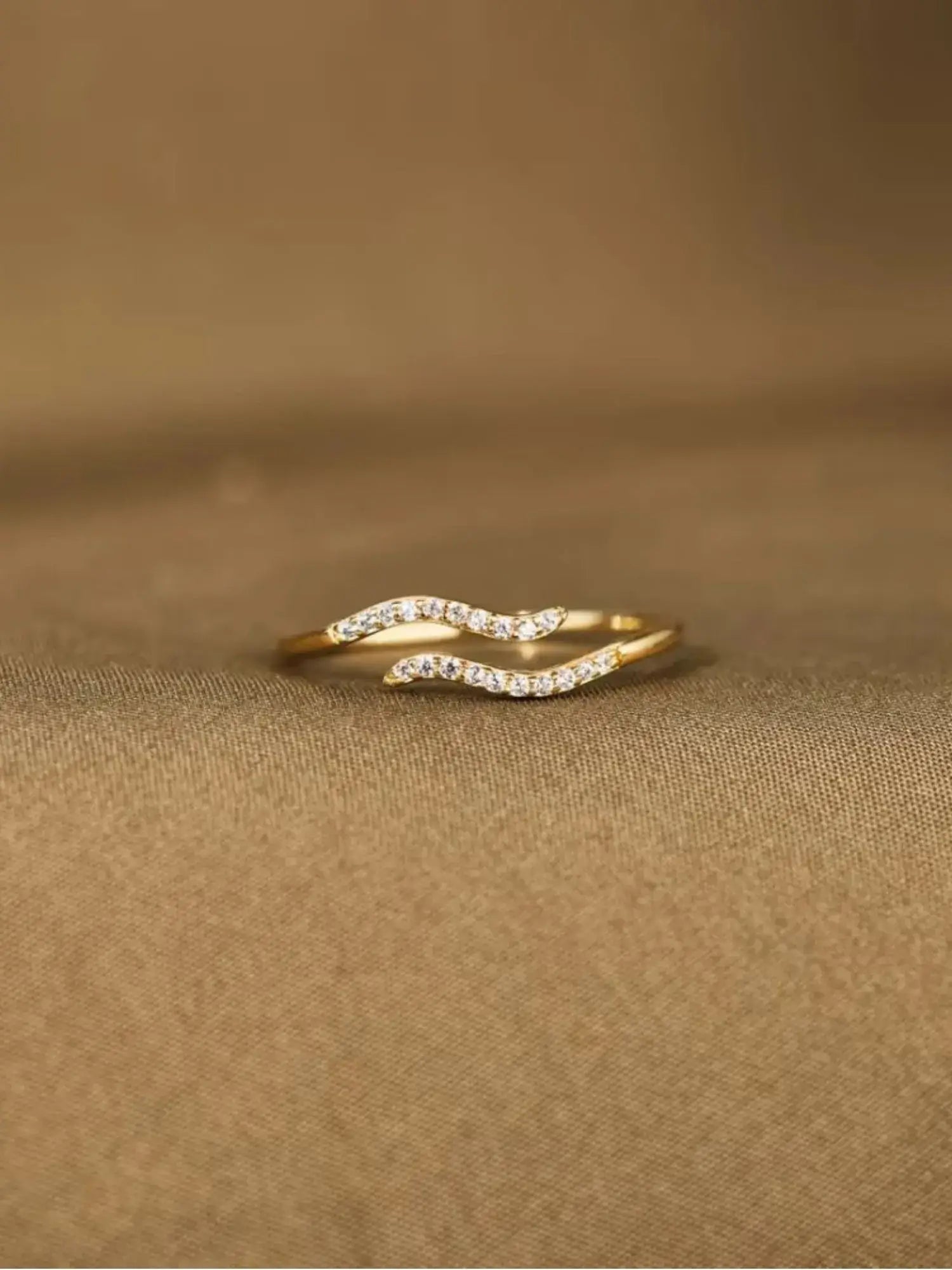 Minimalist Single Wave Ring in 18k gold with pavé-set stones, embodying elegance and quiet strength.