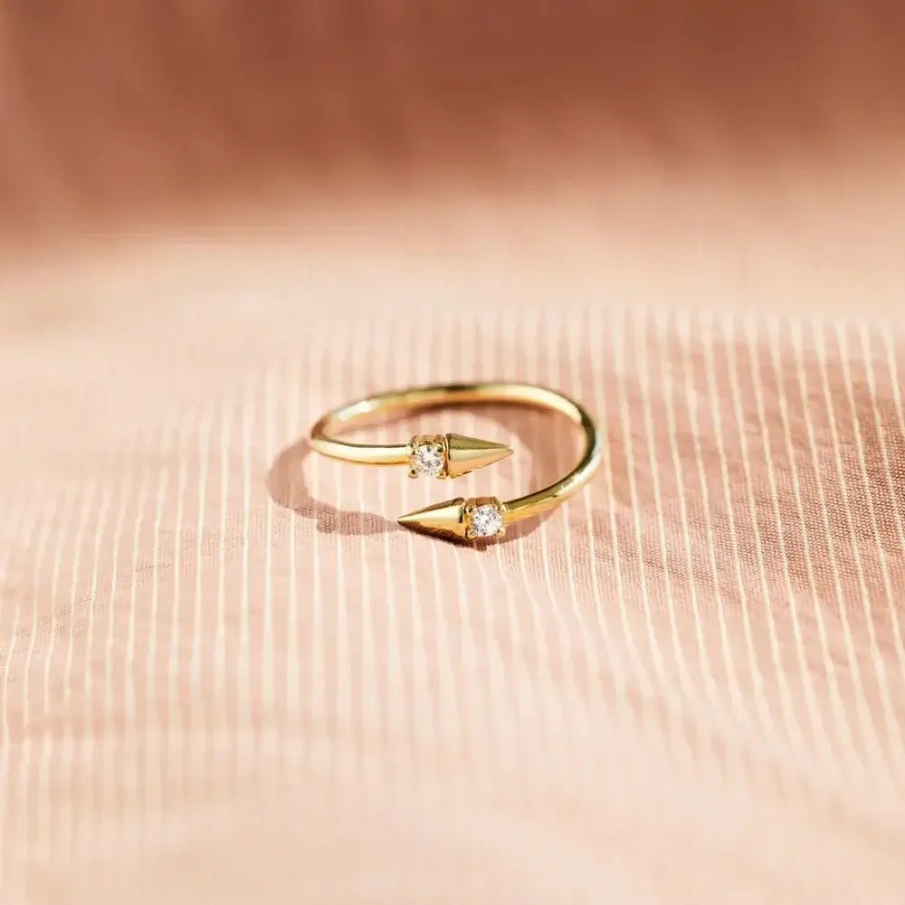 Open Arrow Ring in gold with cubic zirconia accents on adjustable band for a trendy jewelry addition.