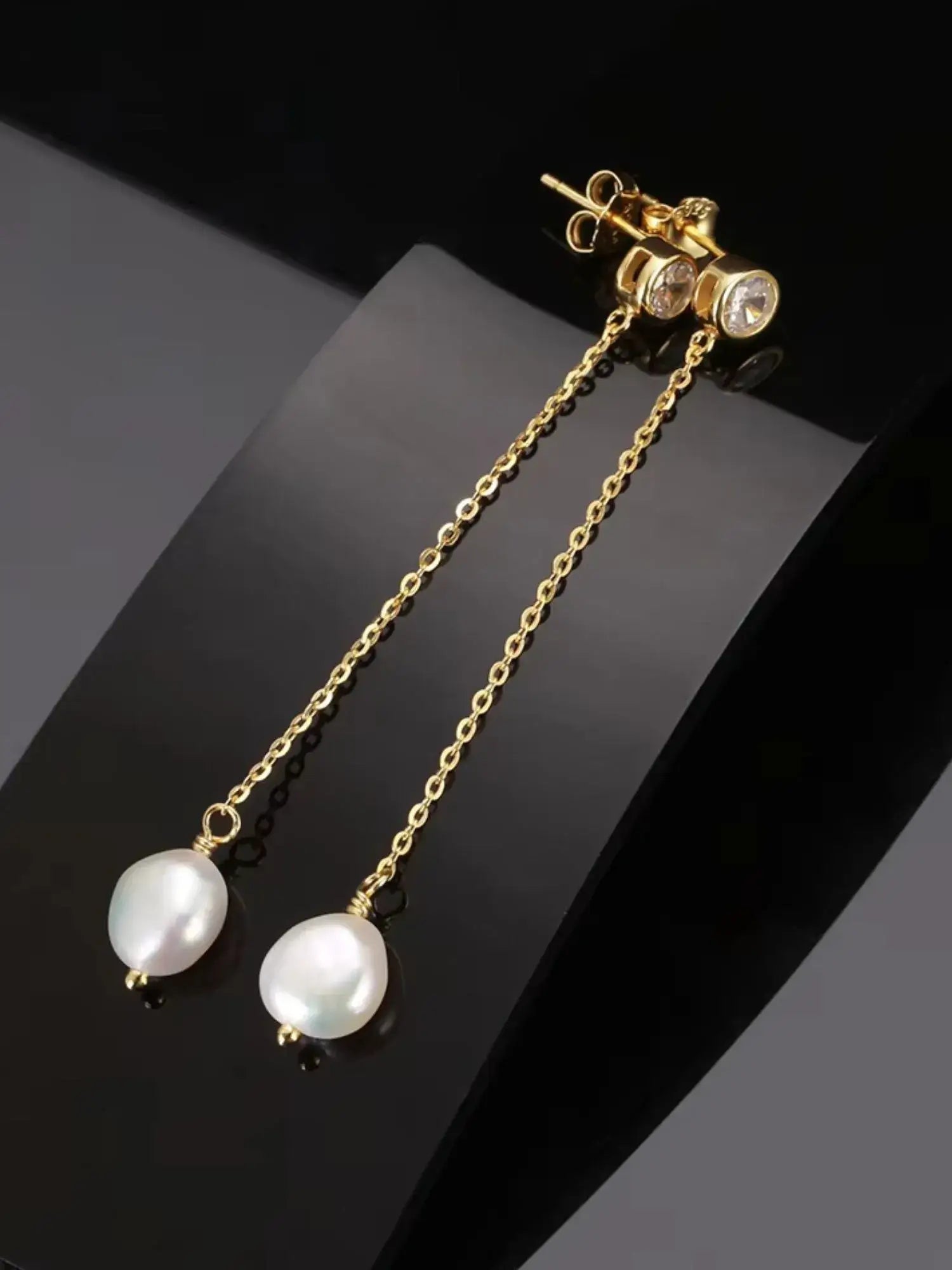 Pearl zirconia drop earrings in gold, showcasing elegant pearls on a delicate chain, perfect for formal or everyday wear.
