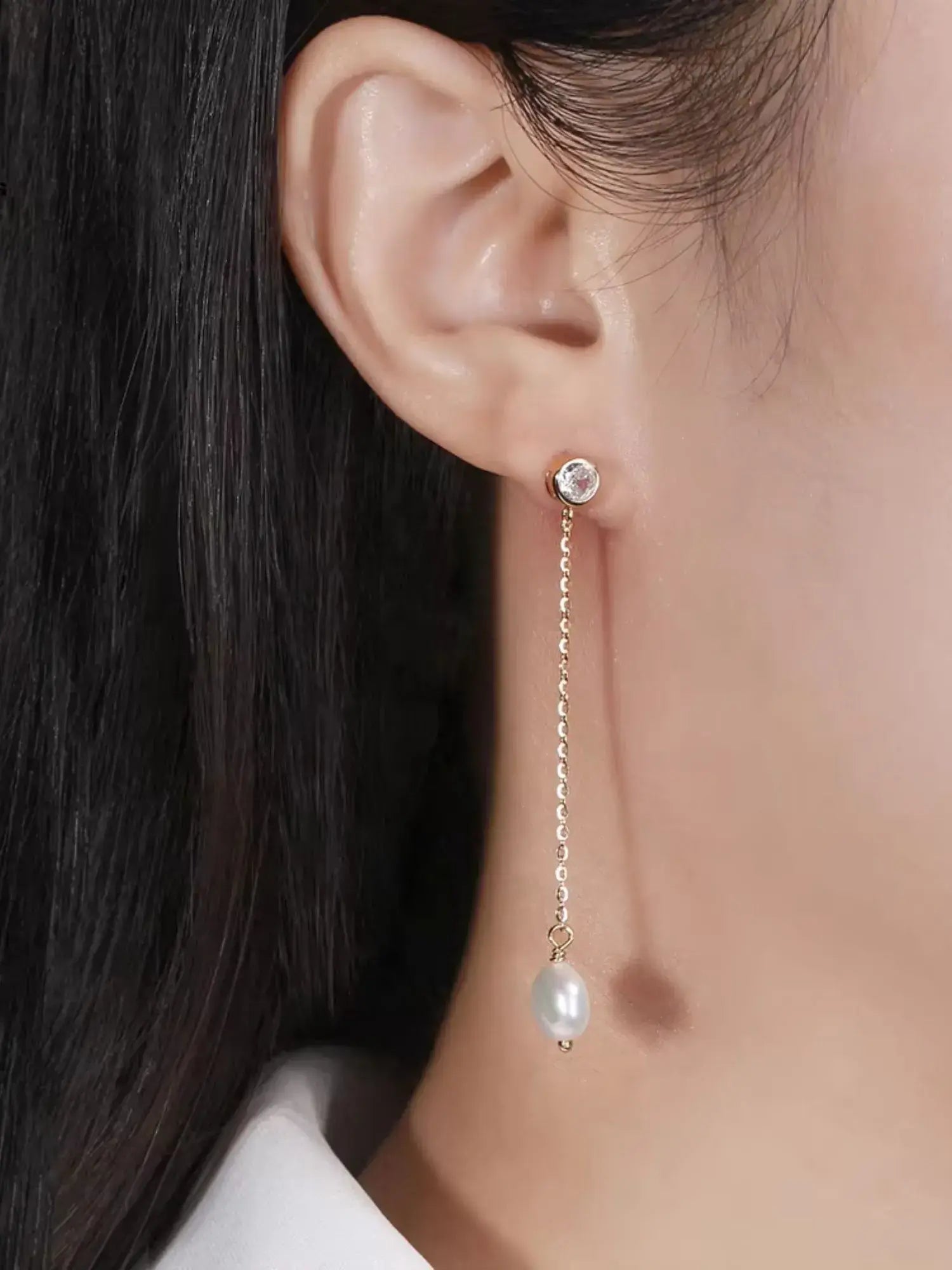 Elegant gold Pearl Zirconia drop earrings featuring a classic pearl and modern chain design for sophisticated style.