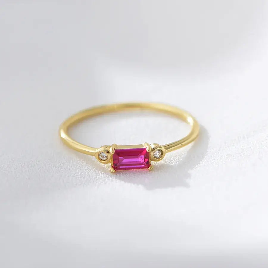 Elegant yellow gold ring featuring a vibrant pink gemstone and sparkling accents, perfect for adding sophistication.