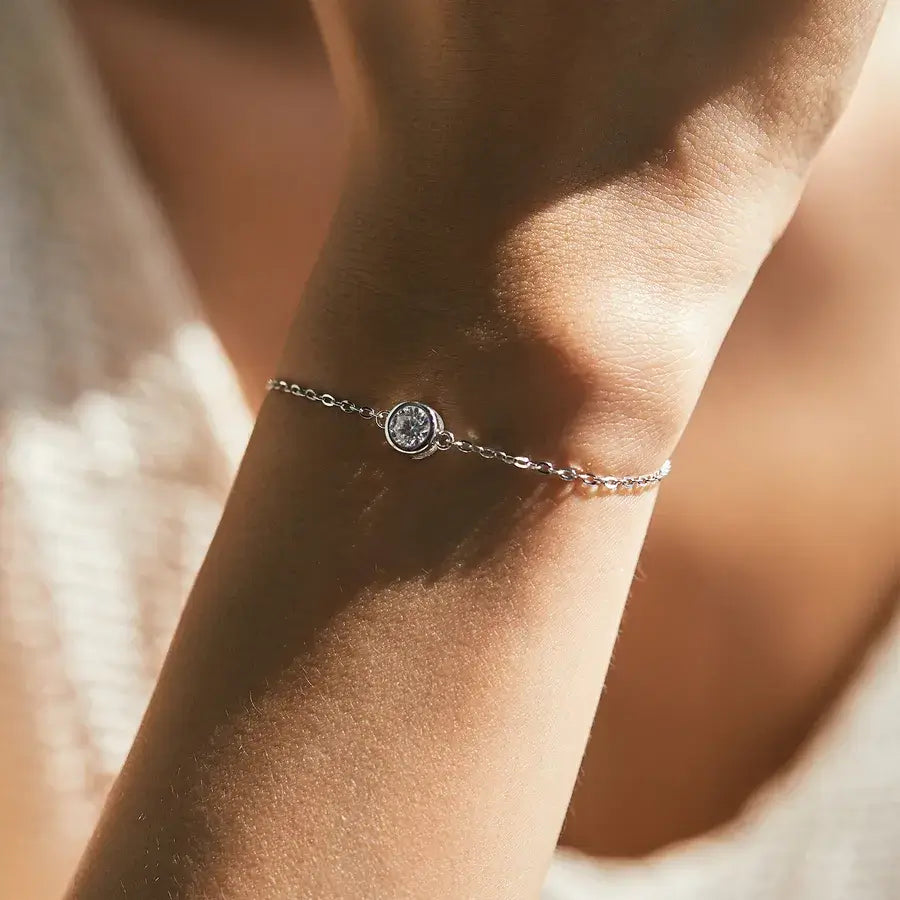0.5 ct moissanite halo bracelet on a woman's wrist showcasing elegant sparkle and simple design.