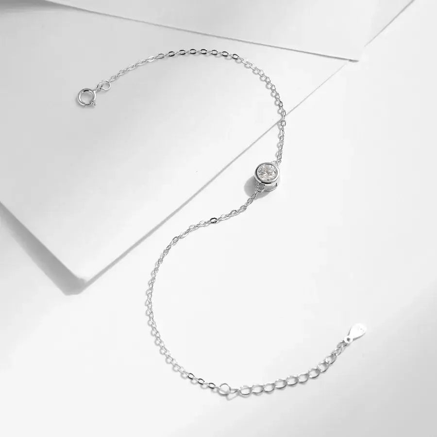0.5 ct moissanite halo bracelet featuring a sterling silver cable chain and a secure bezel-set moissanite centerpiece.