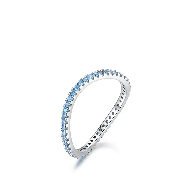 Azure Glow Eternity Band in silver, featuring blue zircon stones, elegant design for stacking or solo wear.
