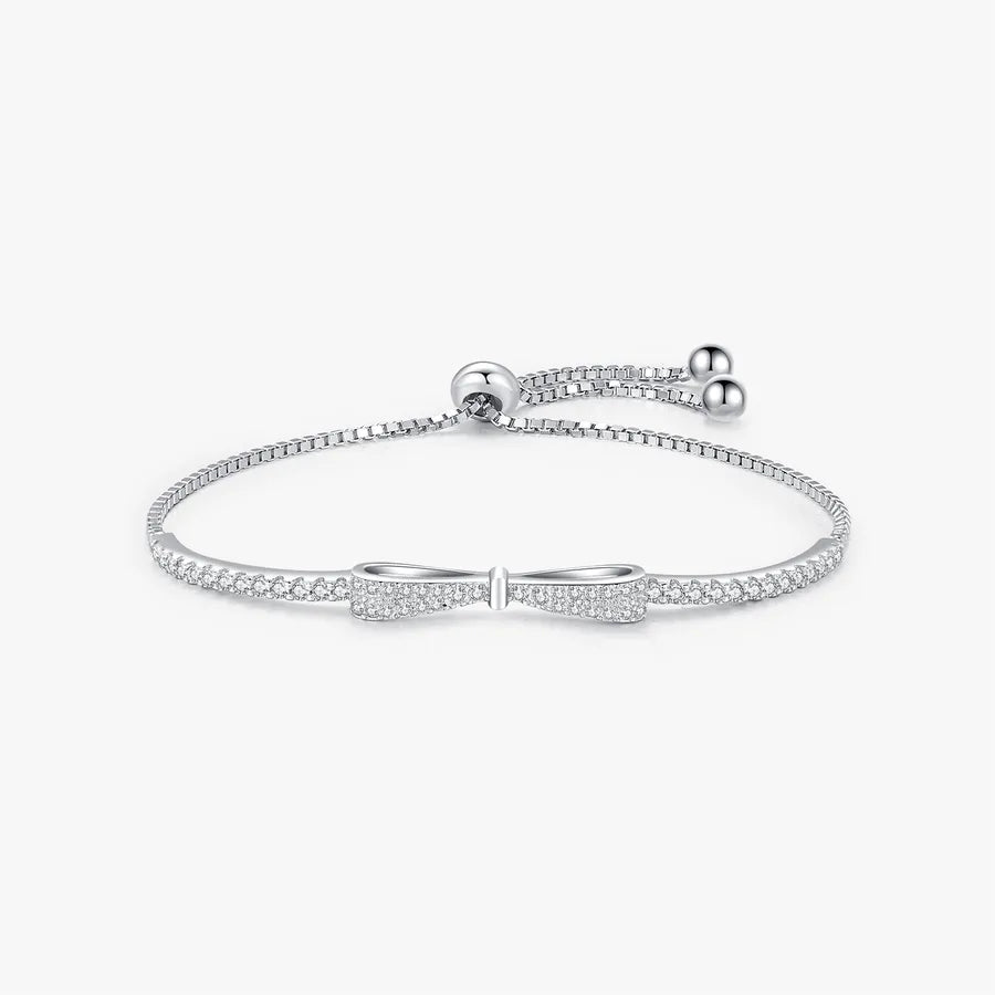 Elegant adjustable bow knot bracelet in sterling silver with zircon stone pave design.