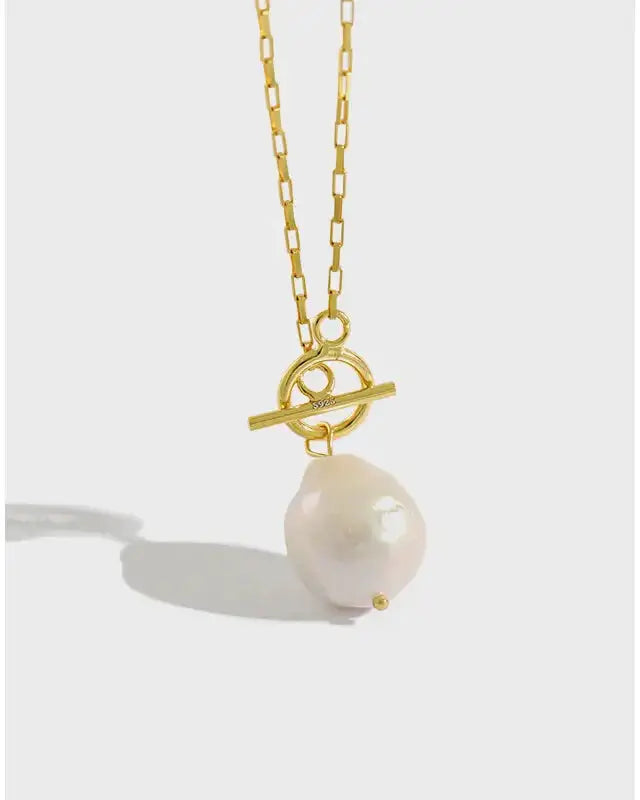 Lia Pearl Pendant Necklace featuring a beautiful pearl on a gold chain, elegant and timeless jewelry for any occasion.