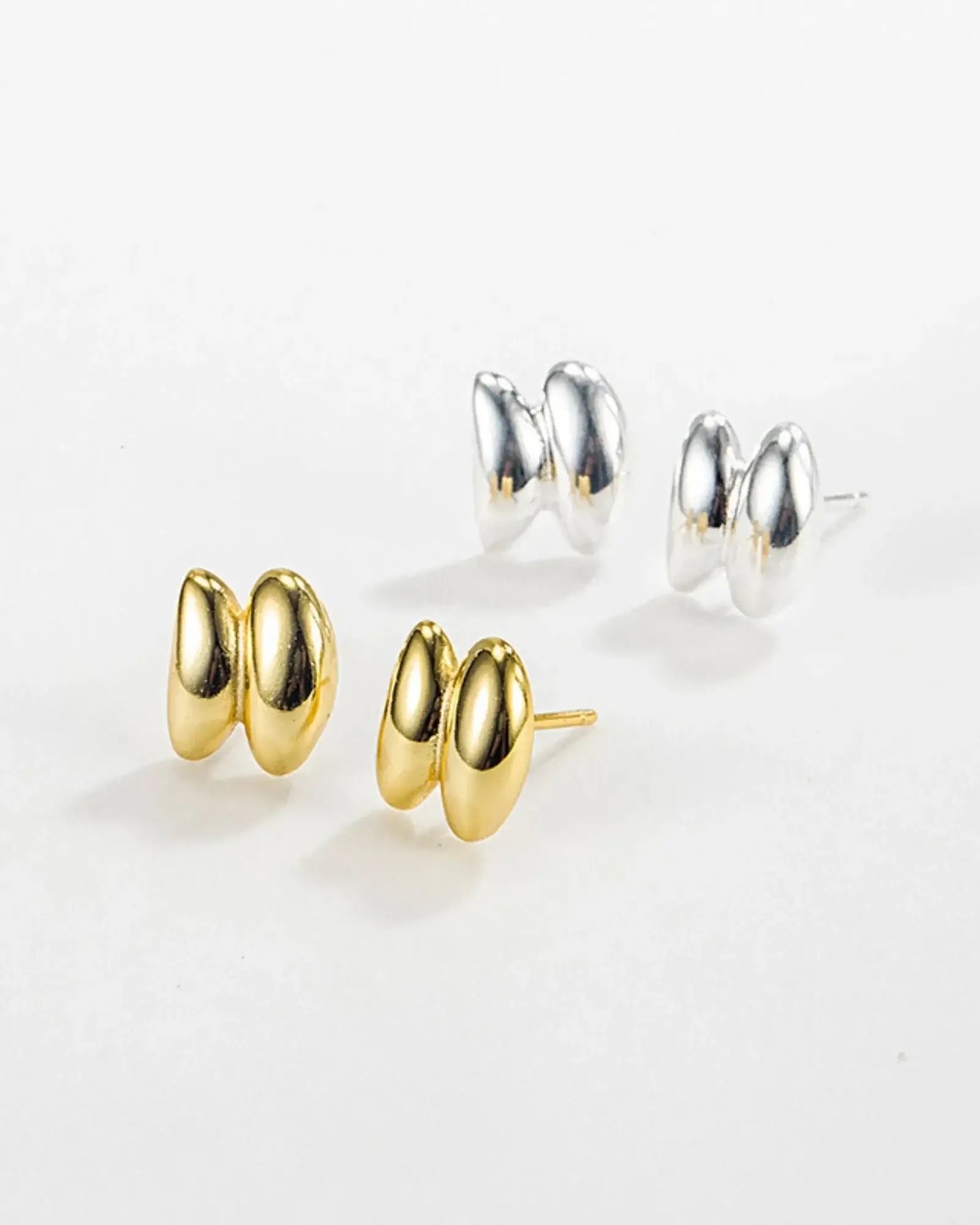Sculptura Ear Studs in gold and silver, crafted from 925 sterling silver, perfect for modern accessories.