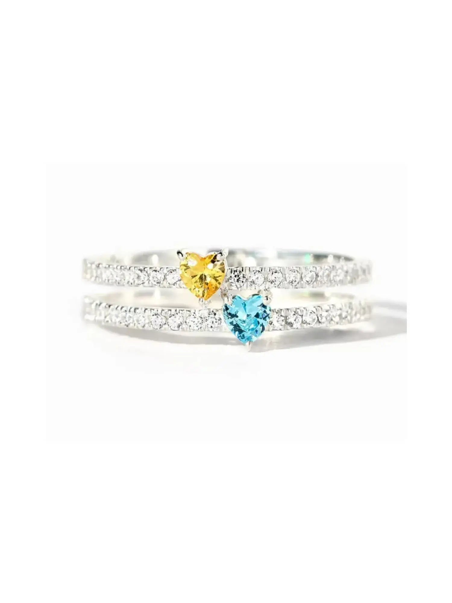 Two Heart Colourful Zircon Ring in sterling silver featuring a yellow and blue heart zircon on a sparkling band.