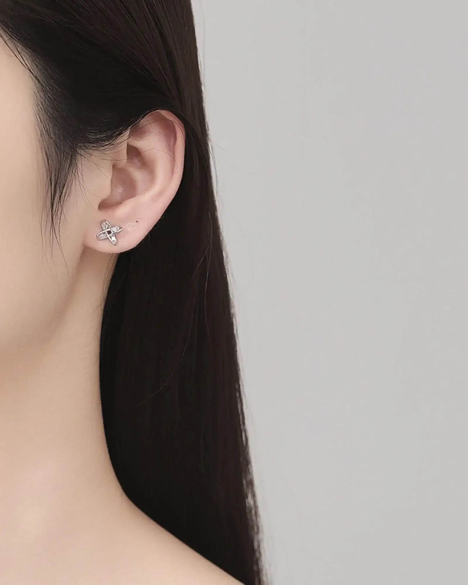 Close-up of a model wearing Windmill Ear Studs made from 925 sterling silver, showcasing elegant design.