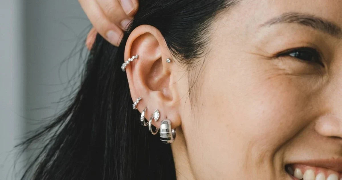 A women styled her sterling silver earring pieces beautifully