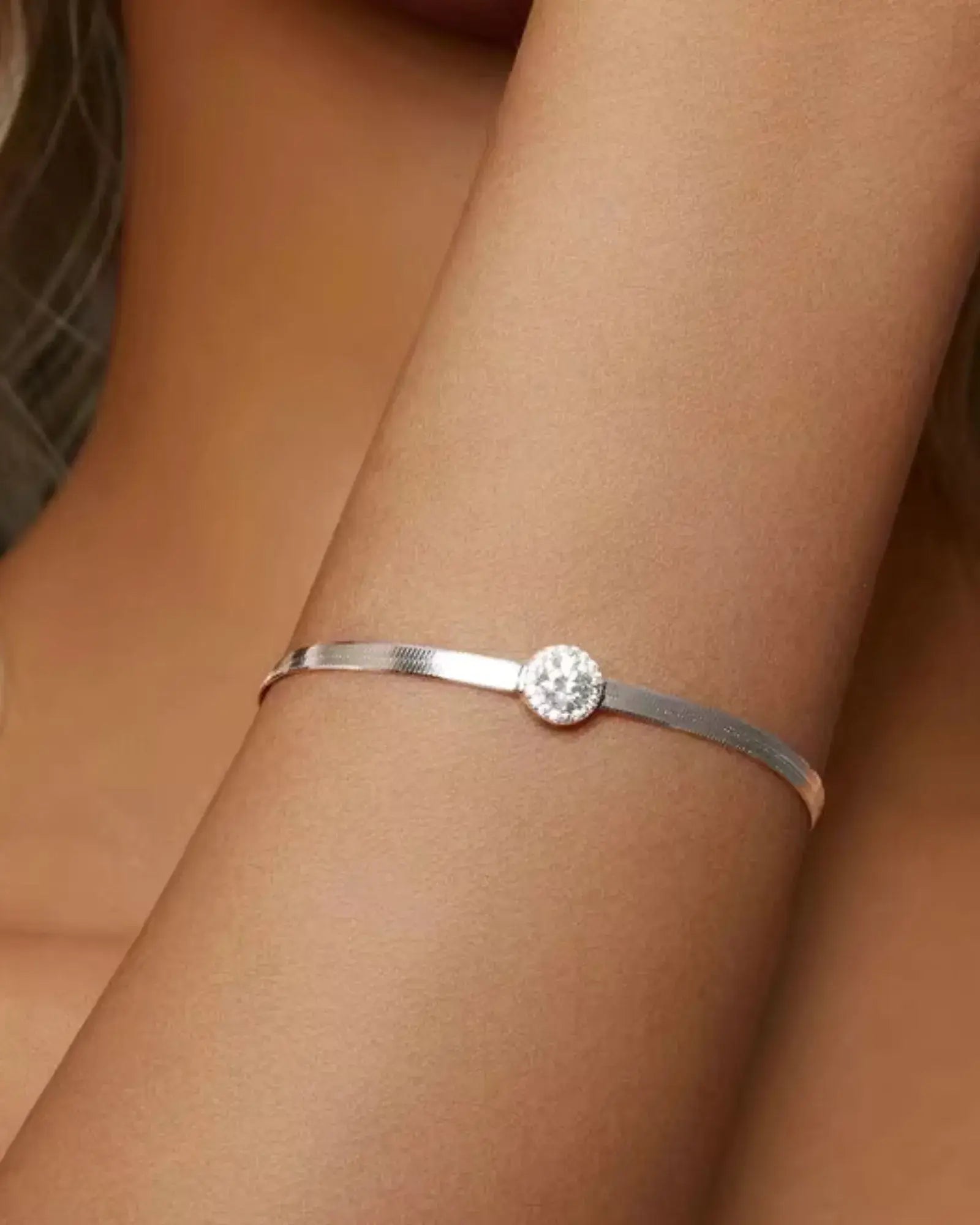 0.5CT Moissanite halo bracelet on a woman's wrist, featuring a 925 sterling silver band and a dazzling centerpiece.