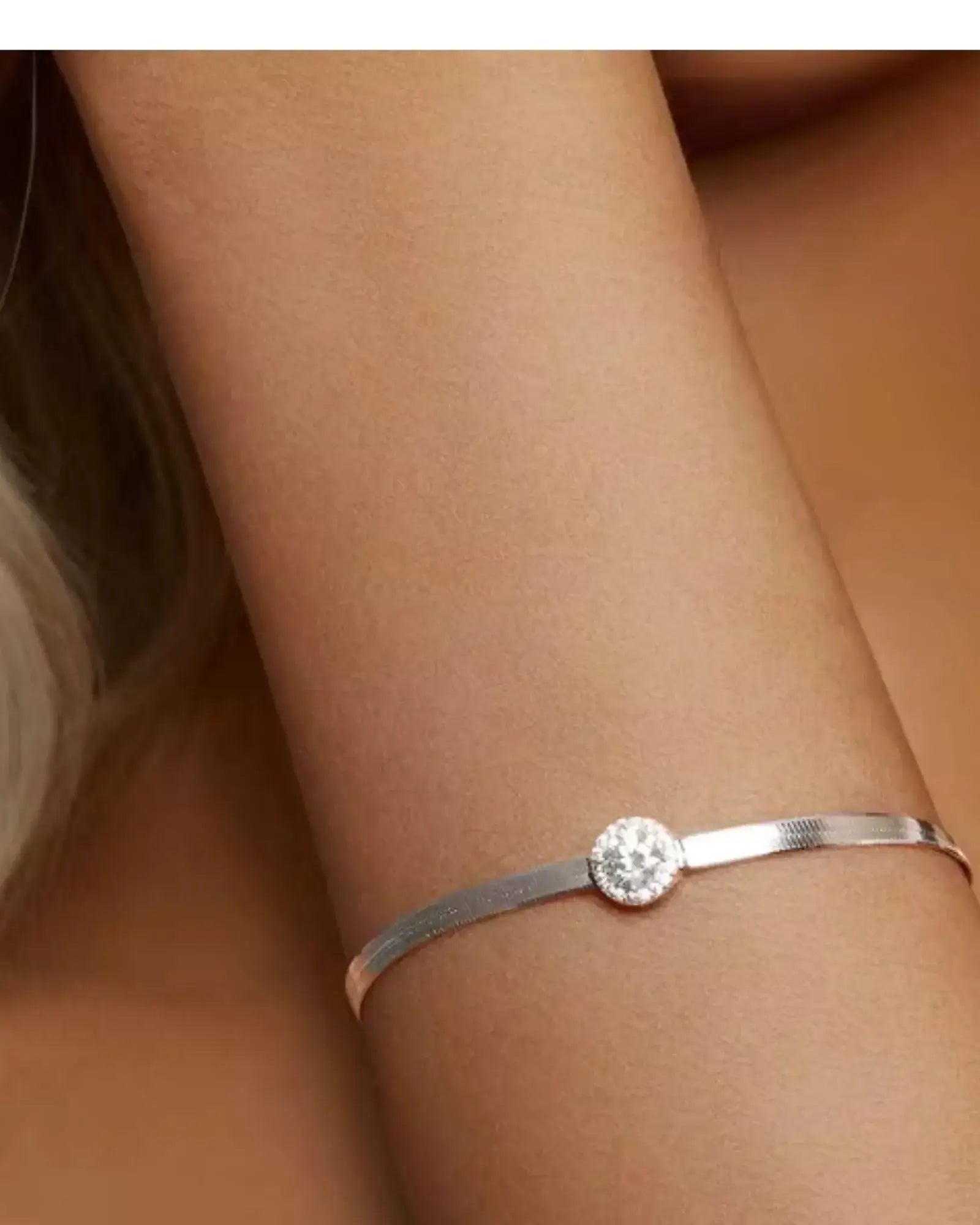 0.5CT Moissanite Halo Bracelet on a wrist, featuring a sterling silver band and sparkling centerpiece.