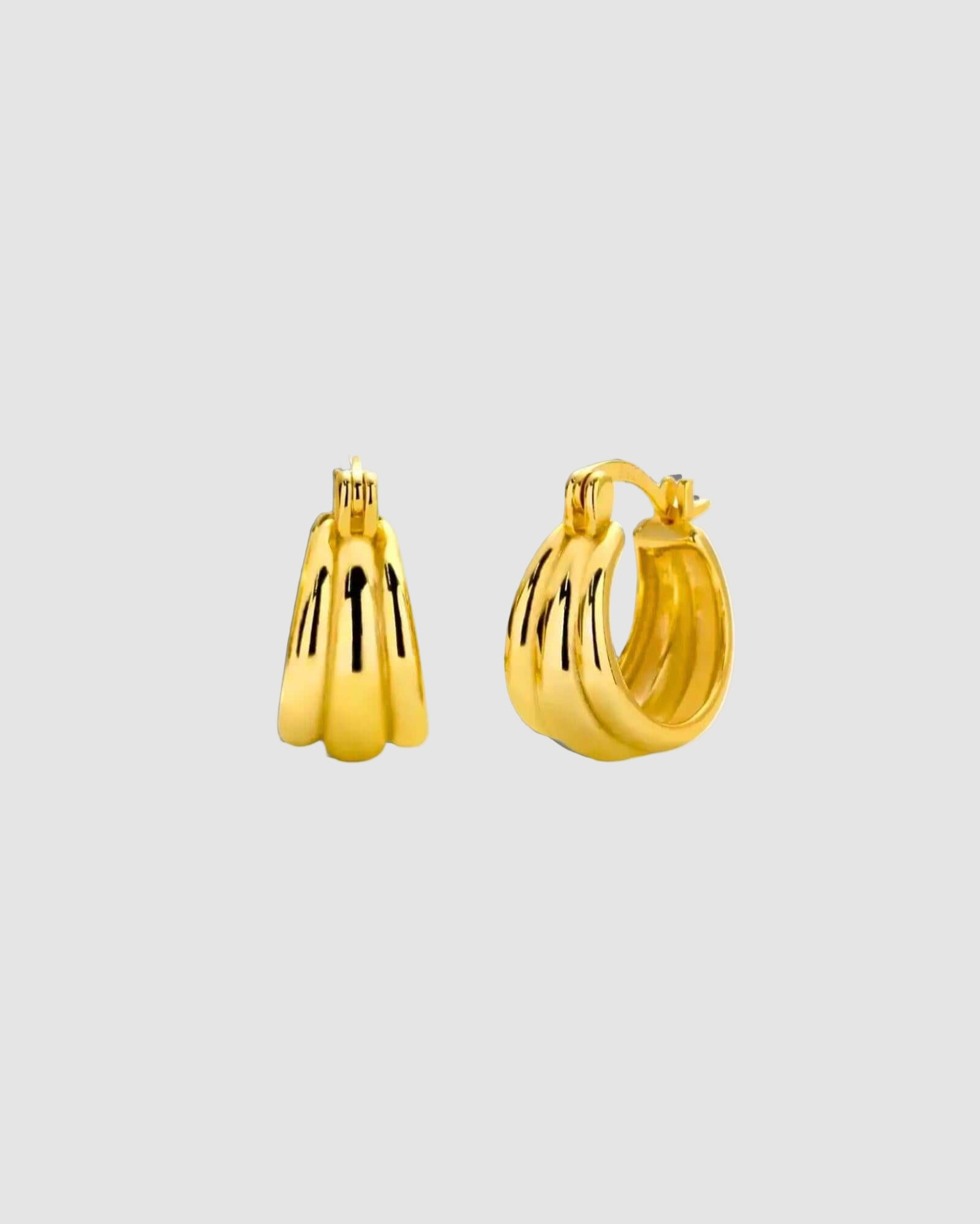 Gold hoop earrings on a white background