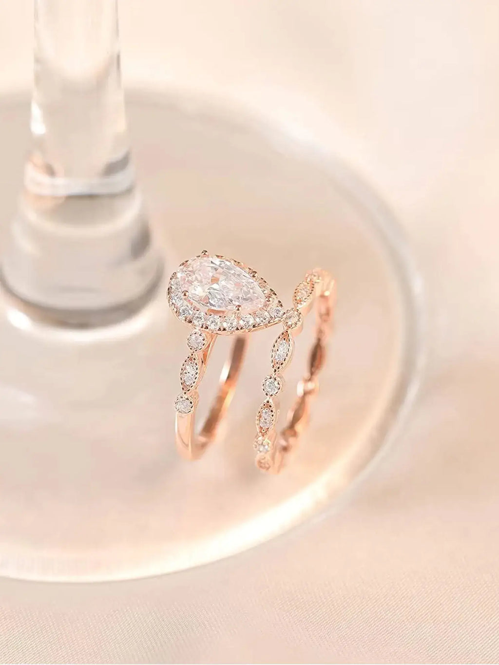 Elegant 1.5CT Teardrop CZ Two Ring Set, crafted in rose gold with sparkling cubic zirconia. Perfect for engagement or gifting.