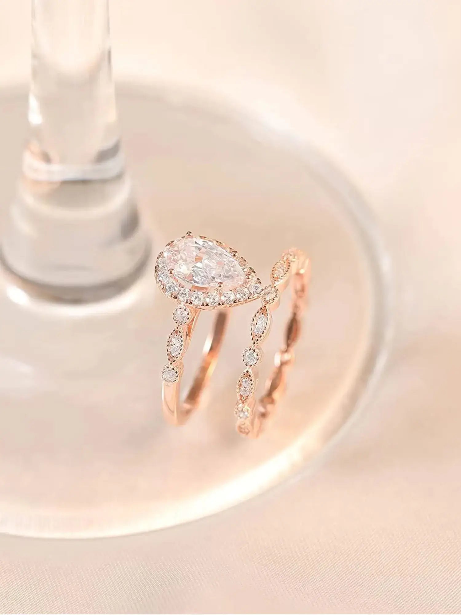 Elegant 1.5CT Teardrop CZ Two Ring Set, crafted in rose gold with sparkling cubic zirconia. Perfect for engagement or gifting.