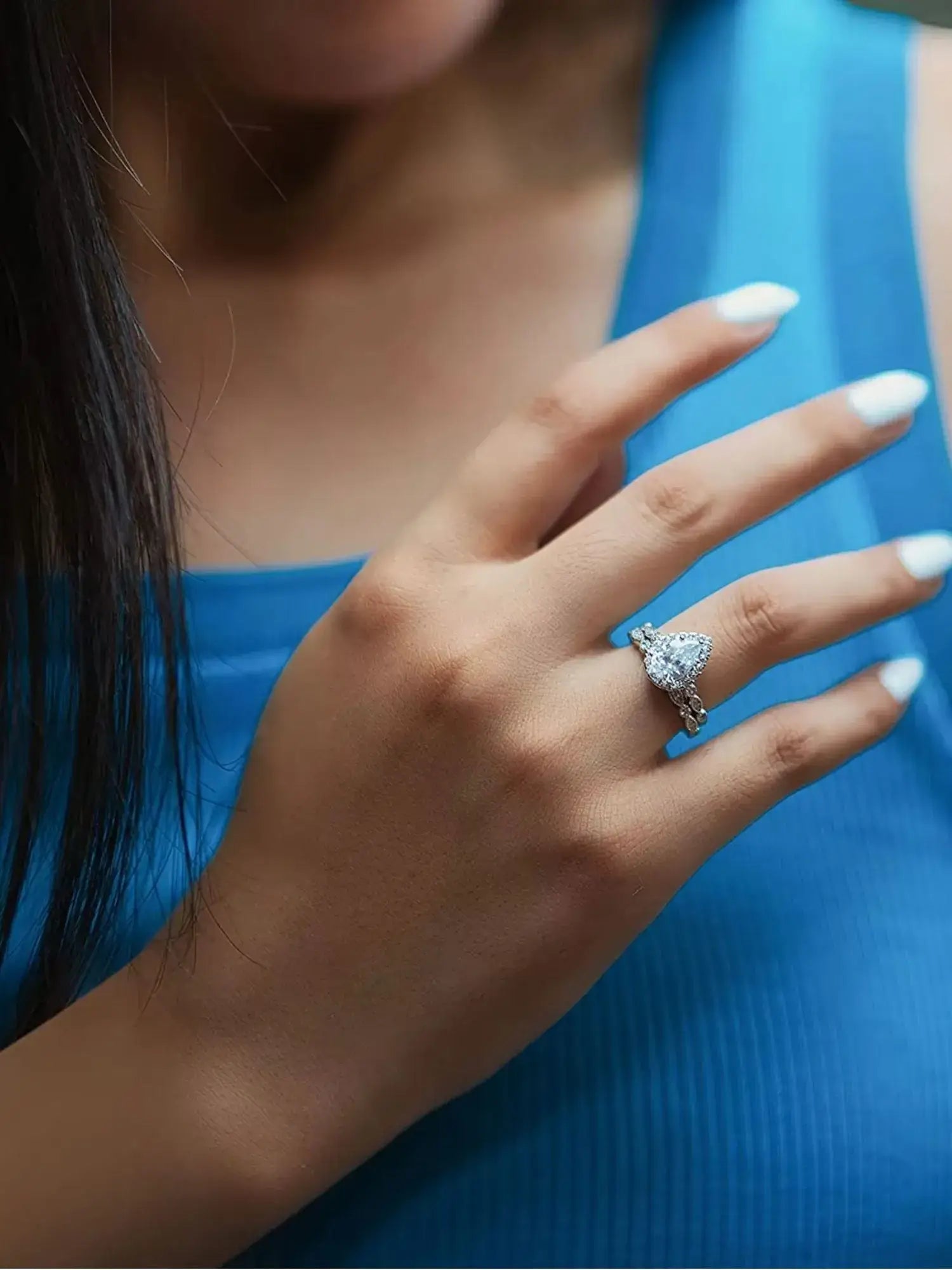 Model showcasing a 1.5CT Teardrop CZ Two Ring Set, highlighting its elegant design and sparkling zircon stone.