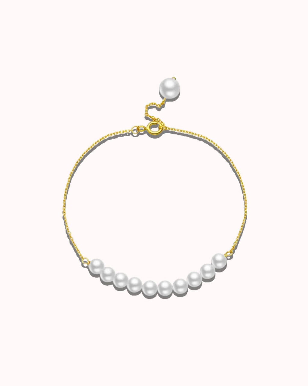 Pearl bracelet with gold clasp on a white background