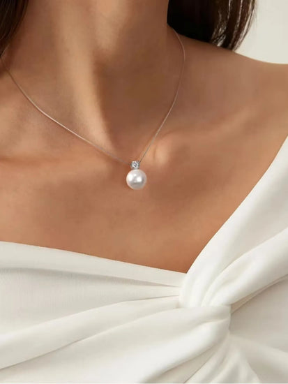 Elegant Maris Pearl Necklace showcased on a model, featuring a AAA-grade pearl pendant and zirconia on a sterling silver chain.